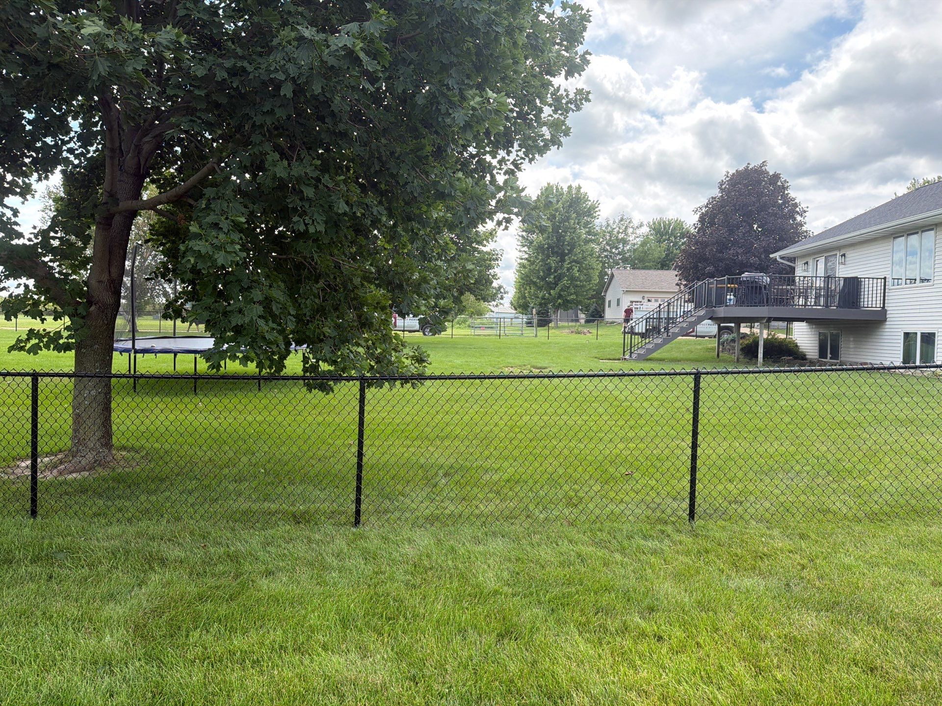 Black Vinyl-Coated Chain Link Fence Installation in Fairbank by Perfect Picket Fence and Stain