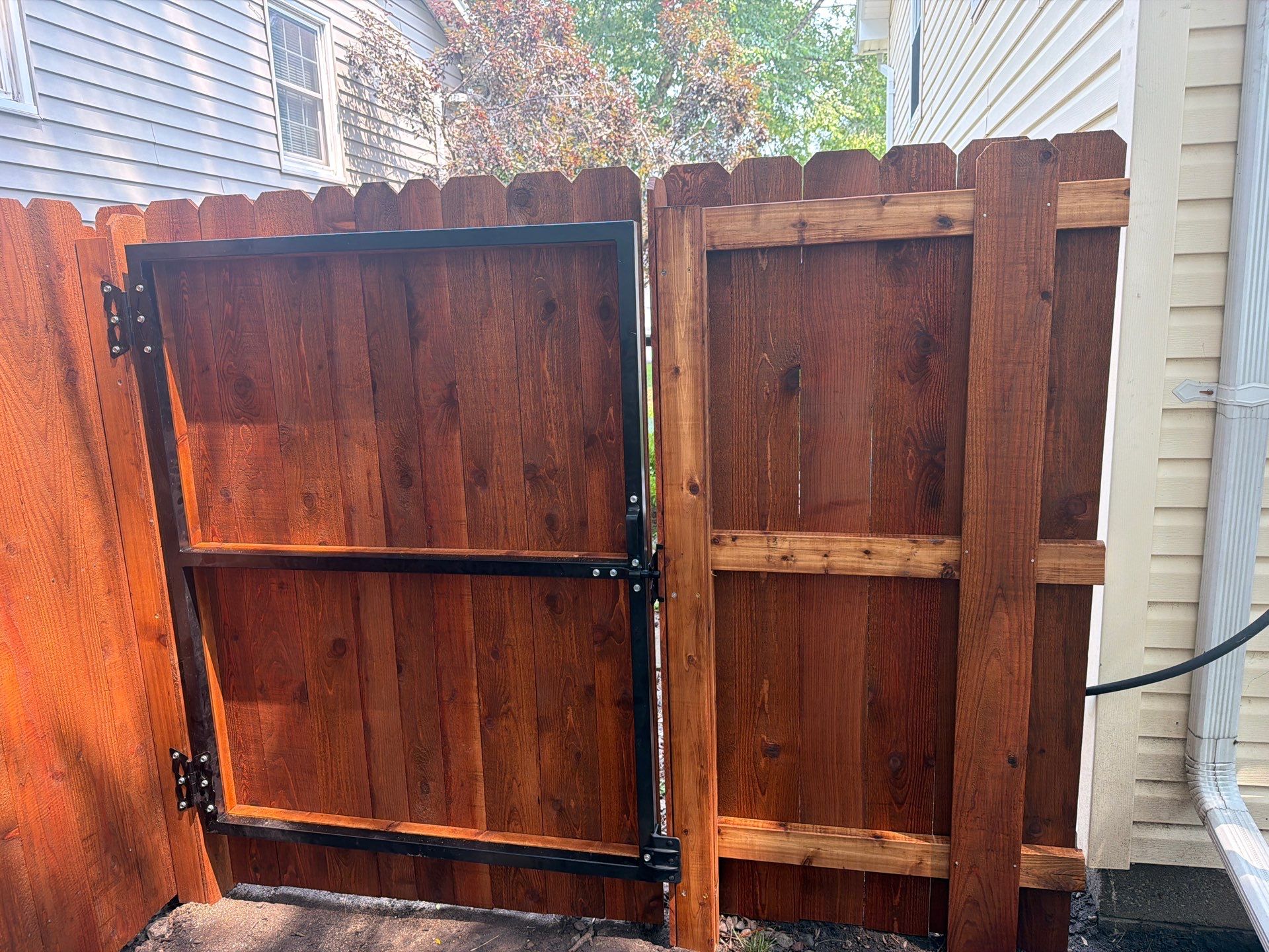 Pecan Cedar Privacy Fence Installation with Scalloped Top in Cedar Falls by Perfect Picket Fence and Stain
