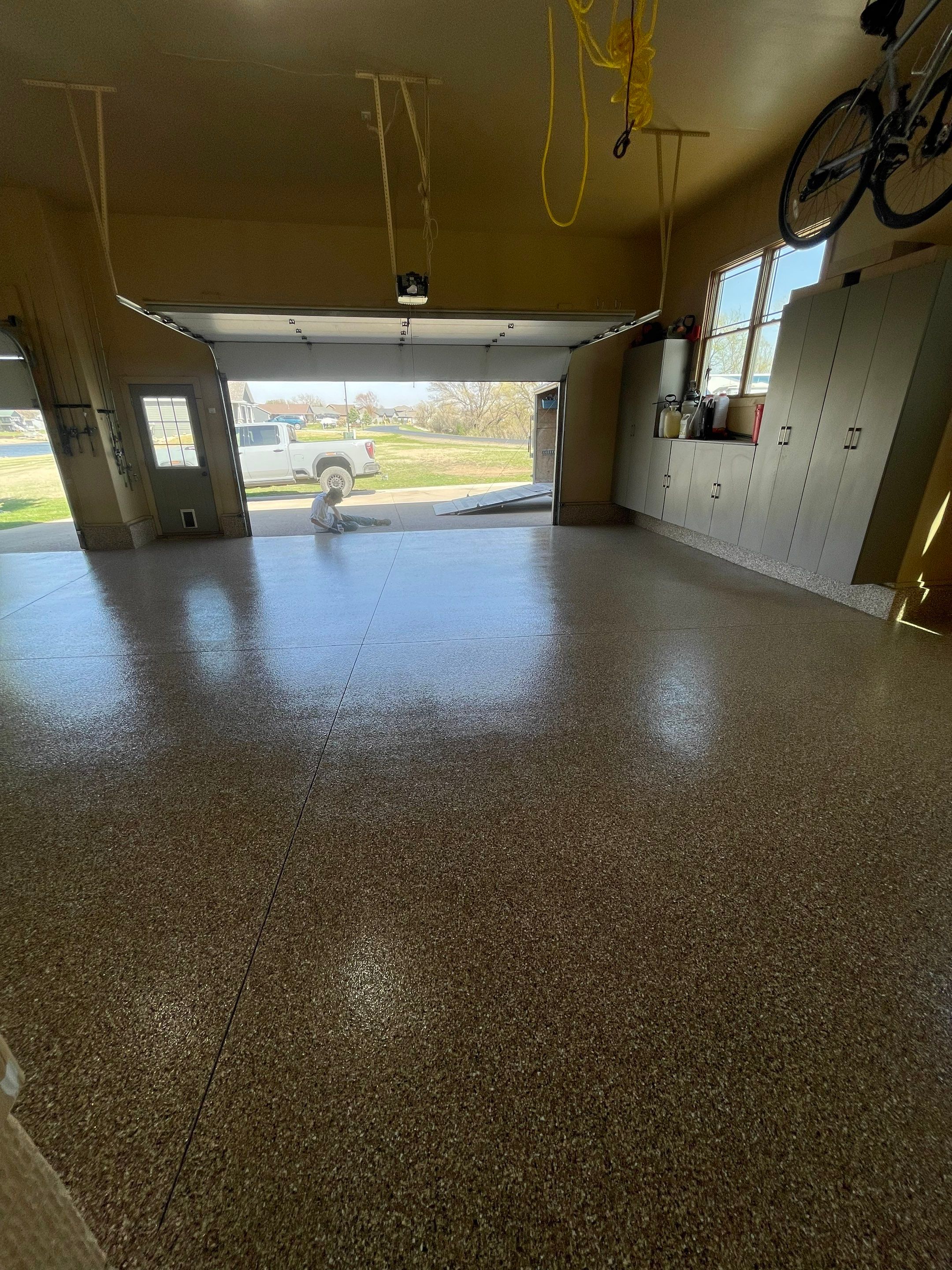 Residential Garage Floor Transformation with Speckled Epoxy Coating by Select Painting, Coatings & Garage Cabinets