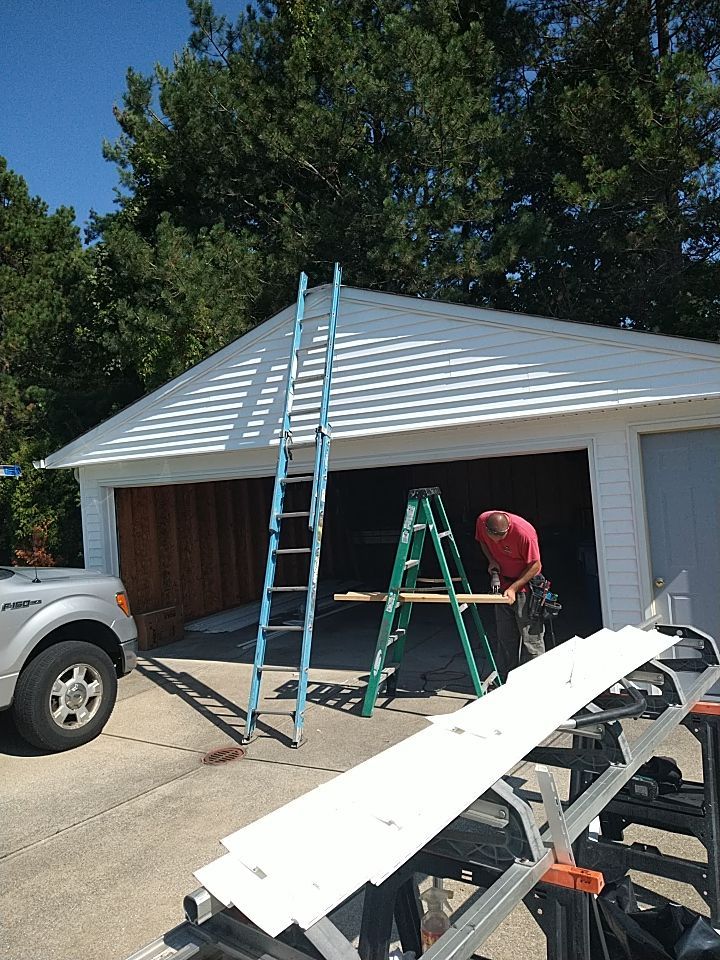 Siding Installation using Norandex woodsman dl-5 white woodgrain vinyl by Absolute Roofing and Construction