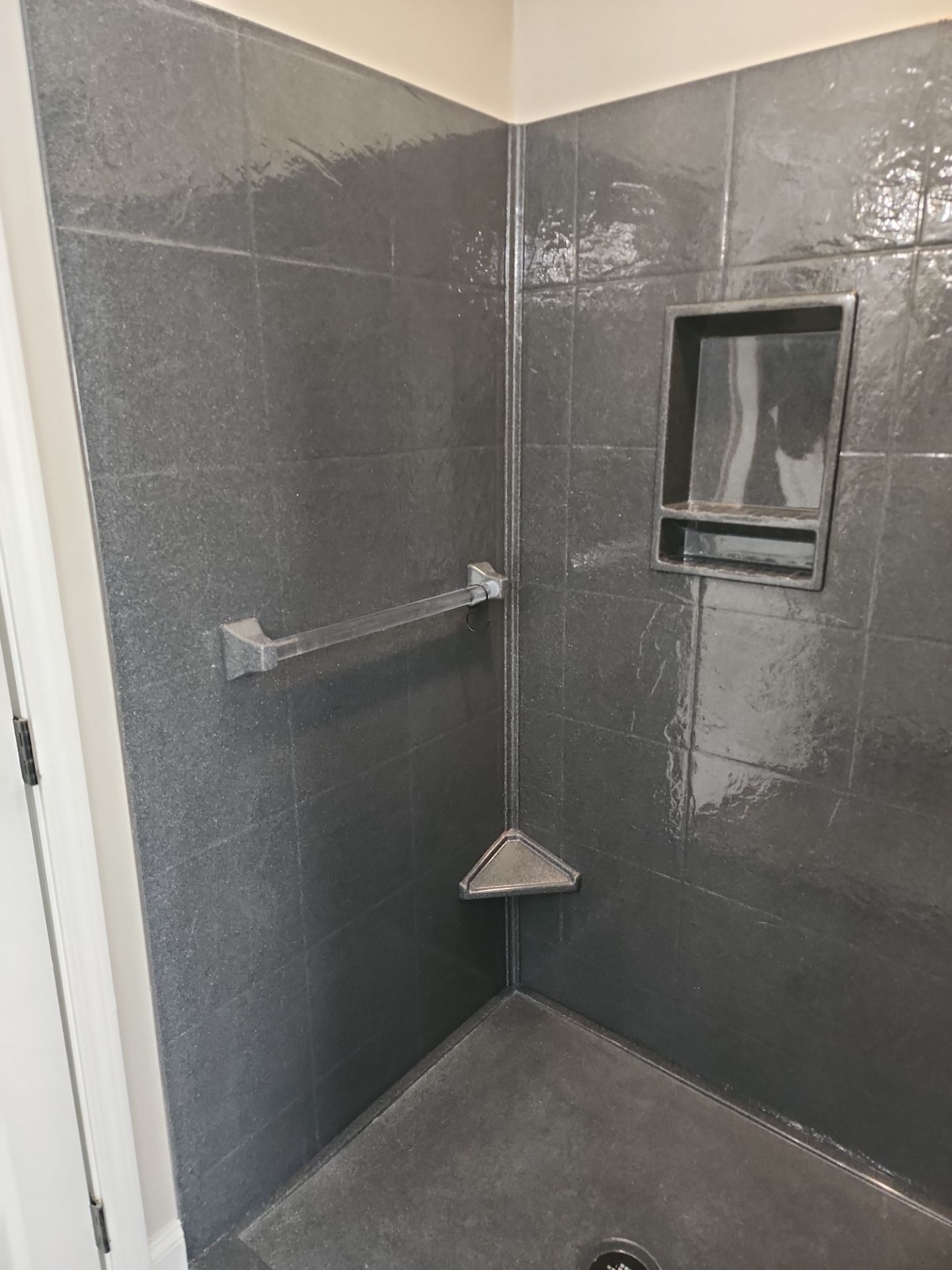 Master Bathroom Renovation Featuring Dark Textured Shower Panels in Branson West by Kitchen Works LLC