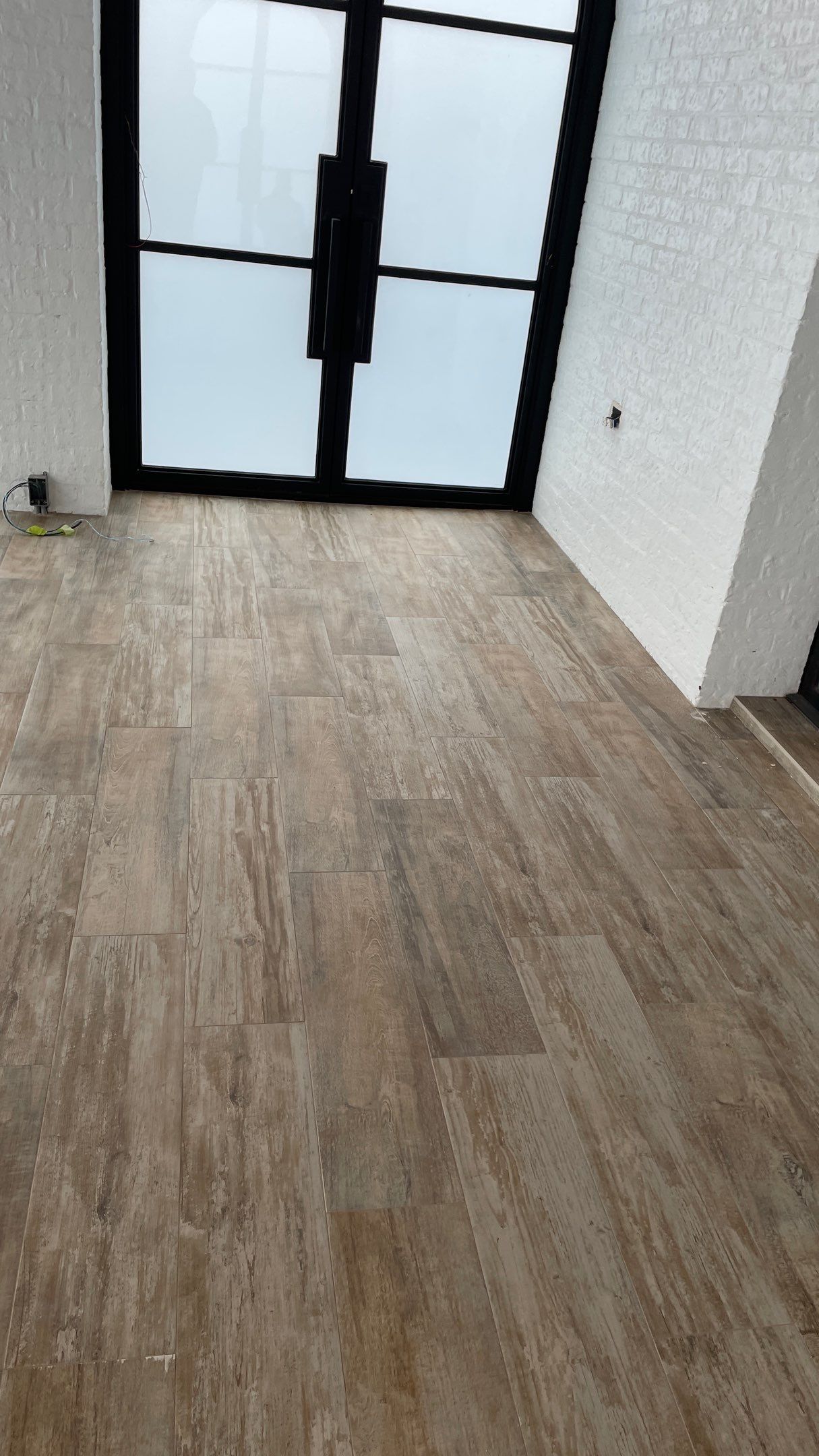 Instant Transformation of this Beautiful Sunroom by Footprints Floors of Coastal Carolina