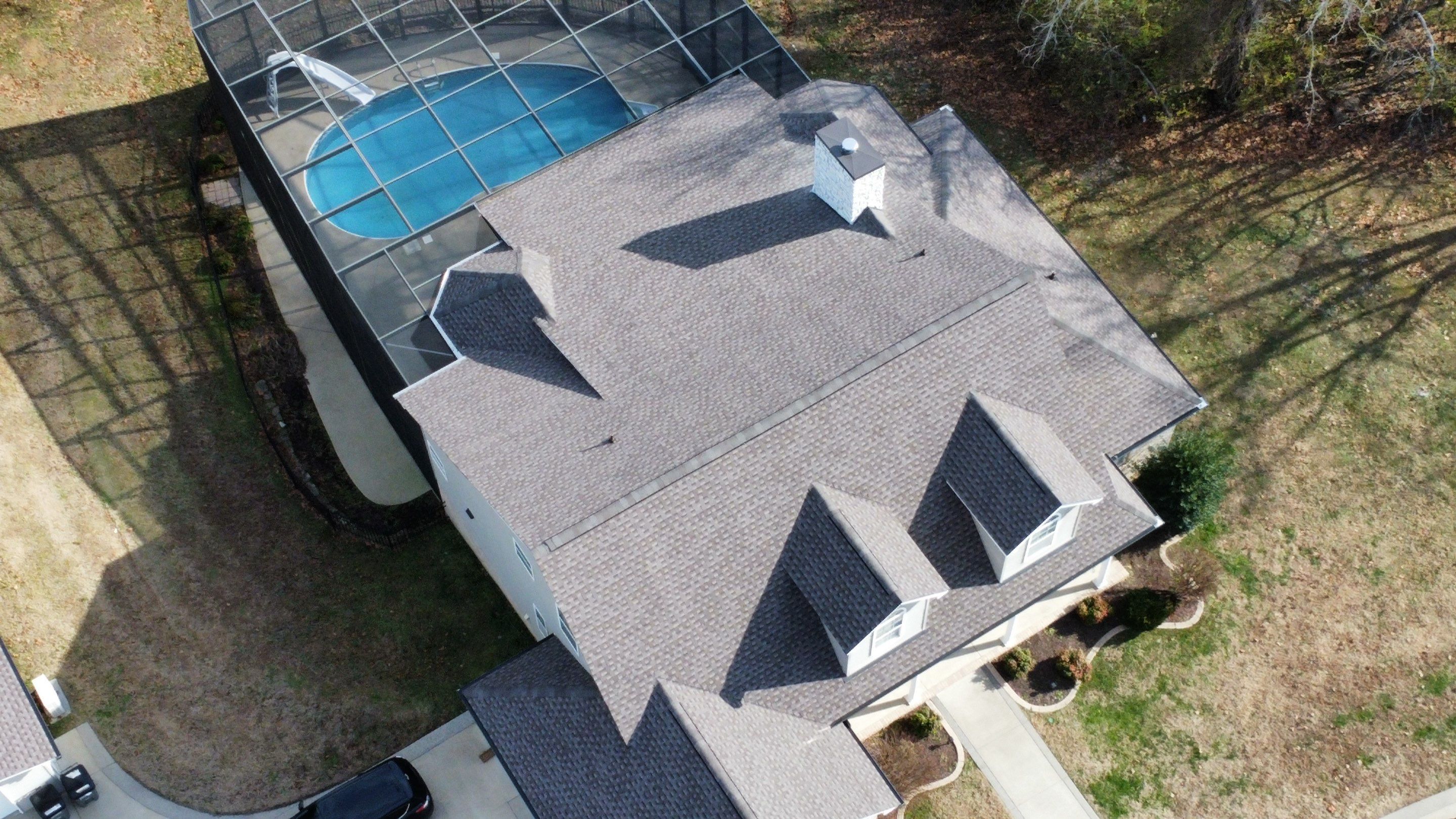 Roof and Gutter System Replacement with Stone Chimney Rebuild by Undersun Roofing 