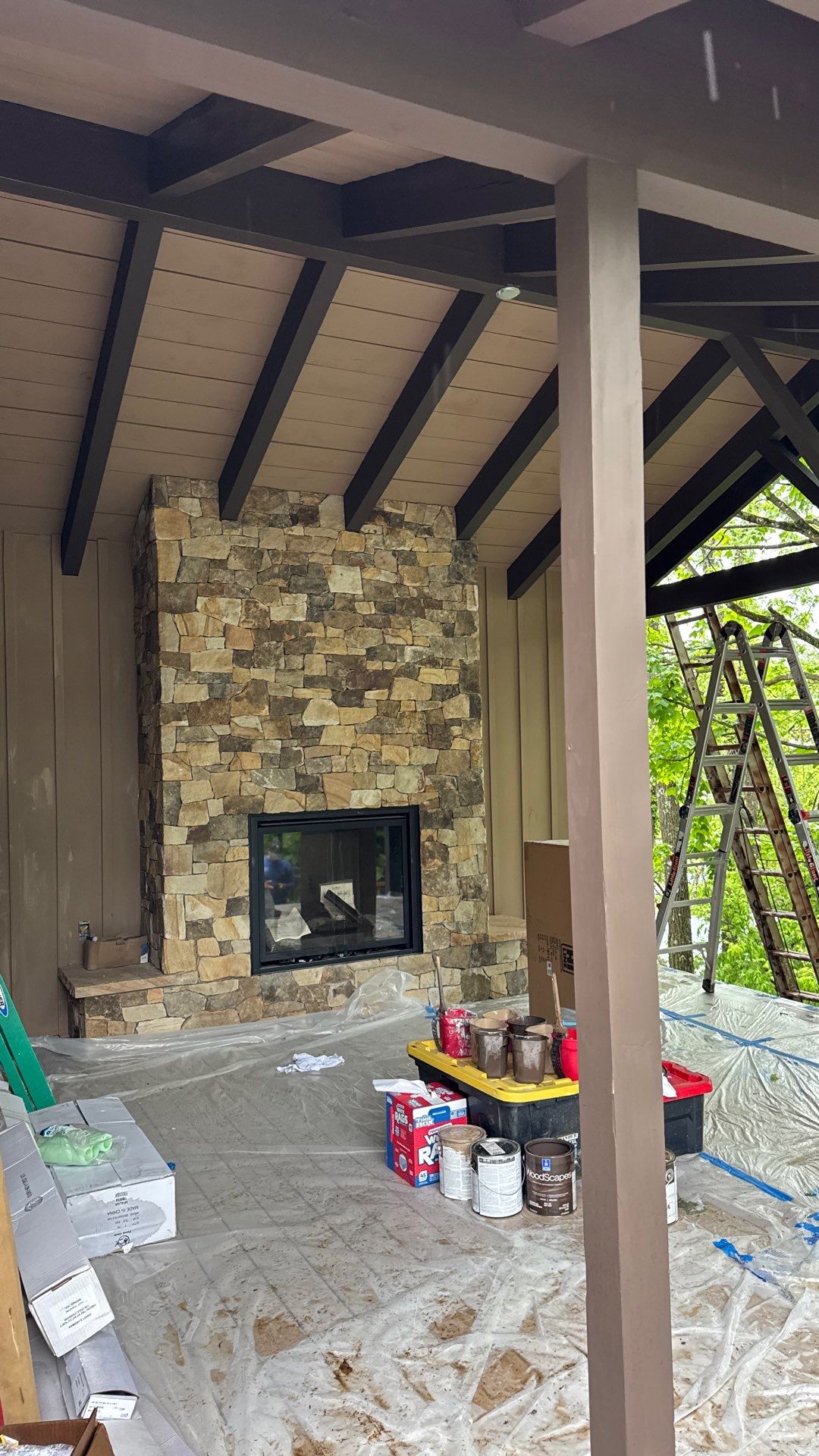 Custom Composite Deck with Stone Fireplace and Modern Cable Railing by Walnut Hollow Decks & Outdoor Living