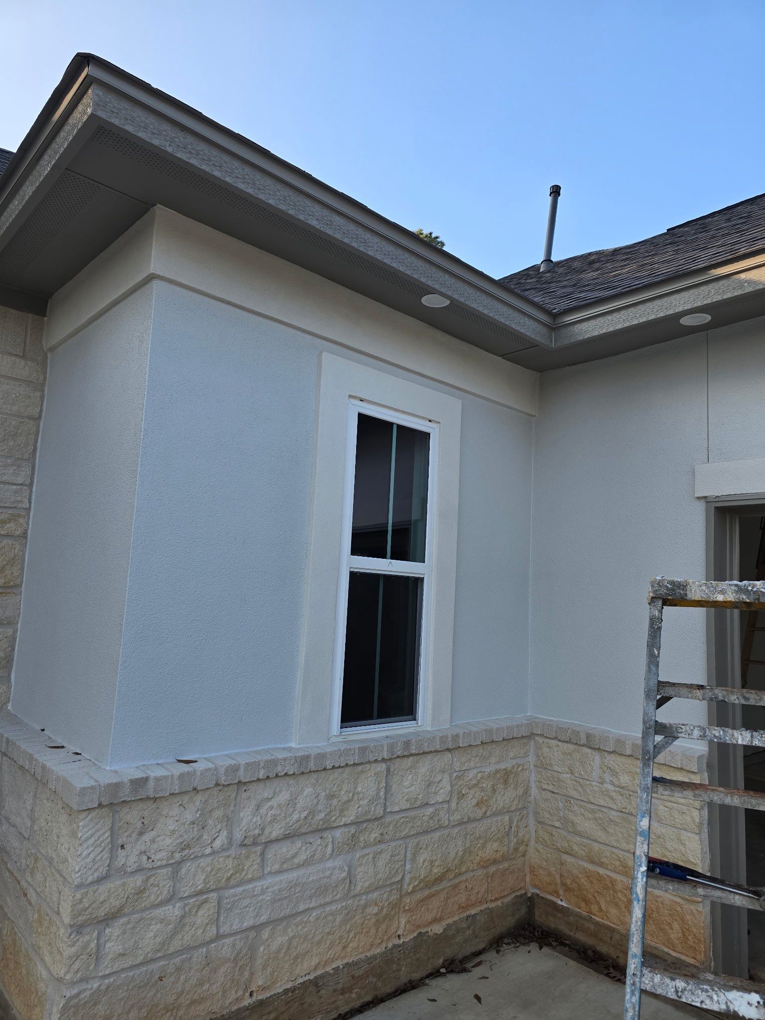 Conroe Elegance: Stucco, Foam Corbels, and Natural Stone Accents. by Apex Conventional Stucco Llc