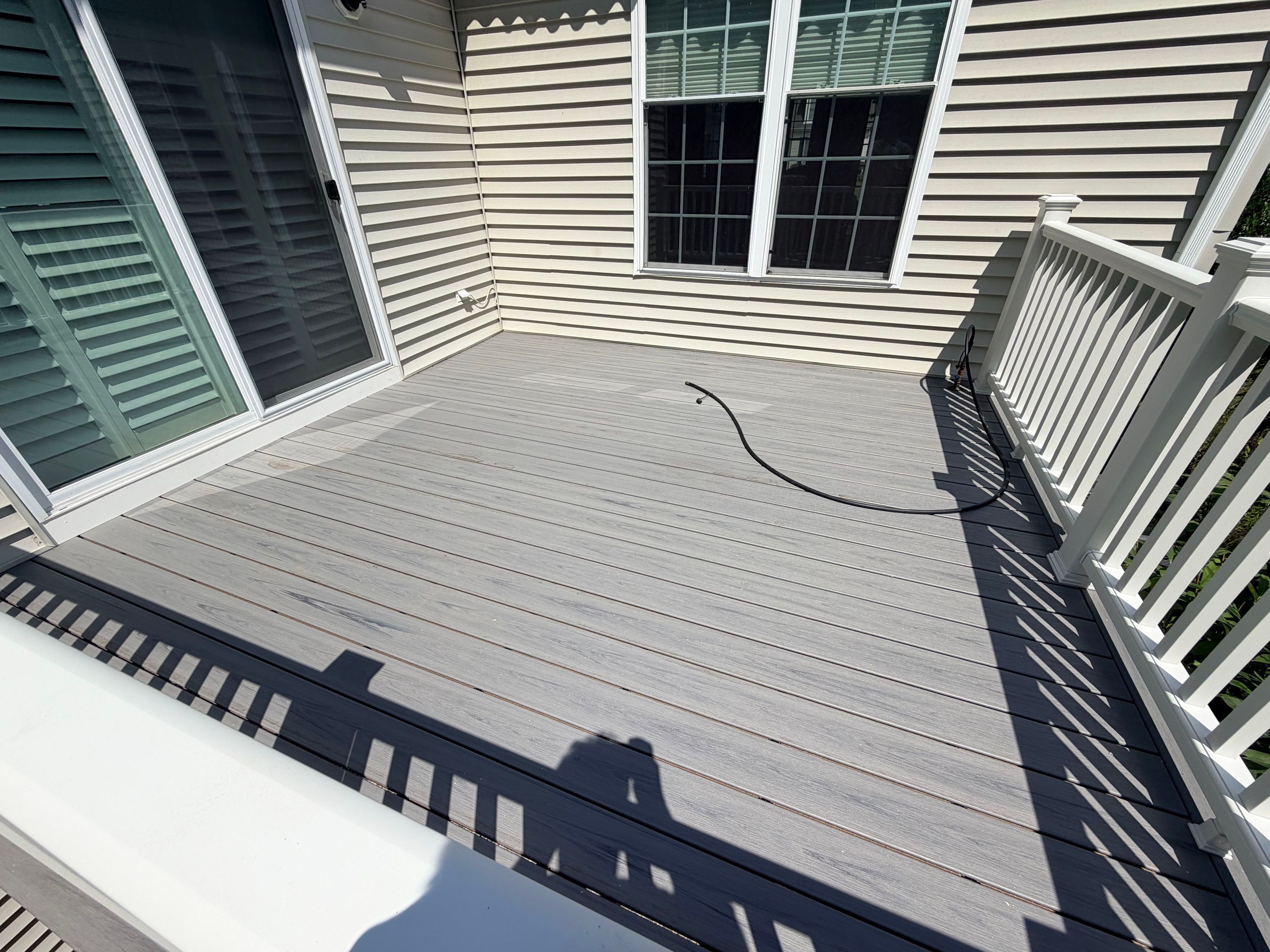 Deck replacement using trex select Millstone with transcend white railing. by DiGiorgi Roofing and Siding Inc