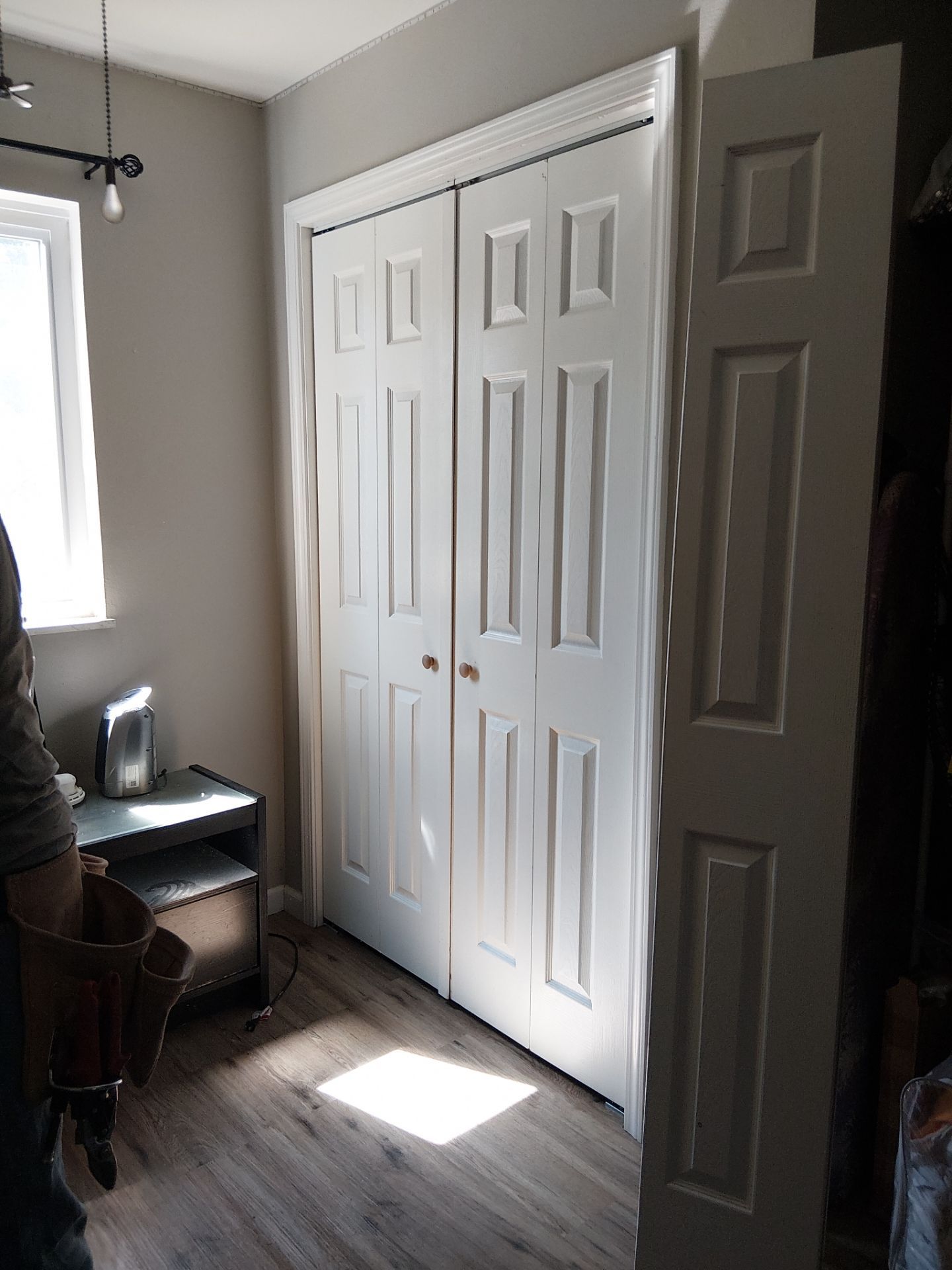 White Paneled Bifold Closet Door Installation by Legendary Services Company LLC.