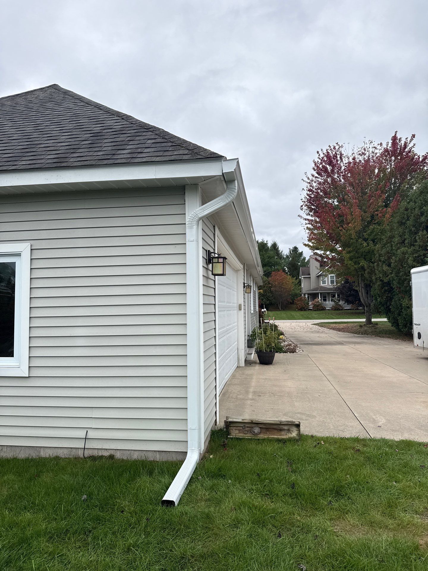 White Gutter System Installation for Traverse City Home by Rainbow Seamless Systems