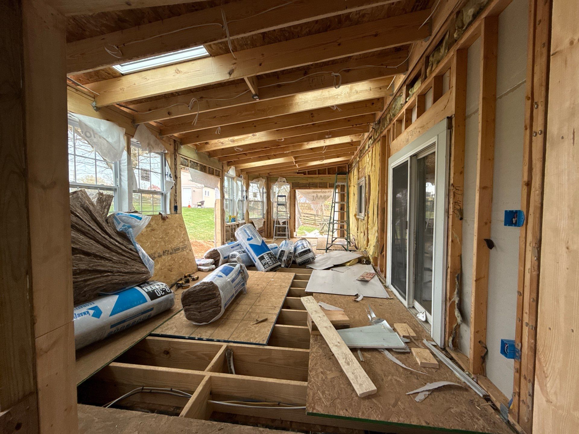 Sun room  using Concrete wood lumber, insulation , drywall, painting , cabinets , laminate floor  . by Jesus Master Handyman LLC 