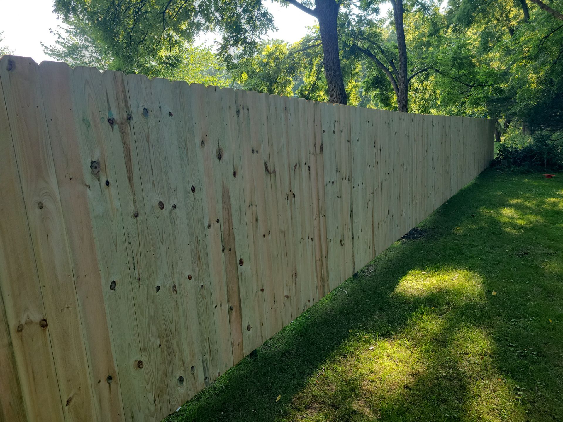 Pressure-Treated Wood Privacy Fence Replacement in Cedar Falls by Perfect Picket Fence and Stain