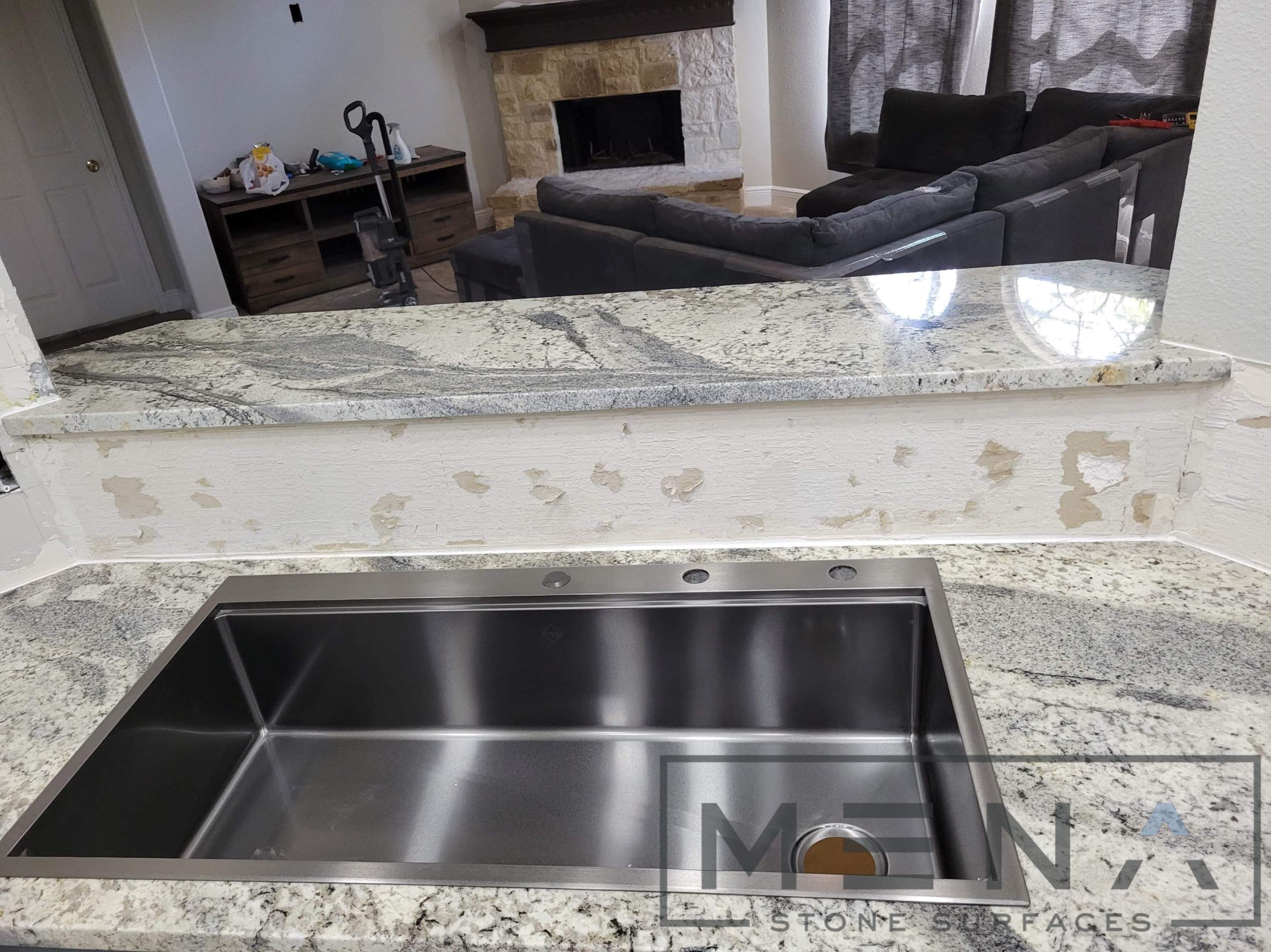 Kitchen countertops using Alaska Blue Granite by Mena stone surfaces