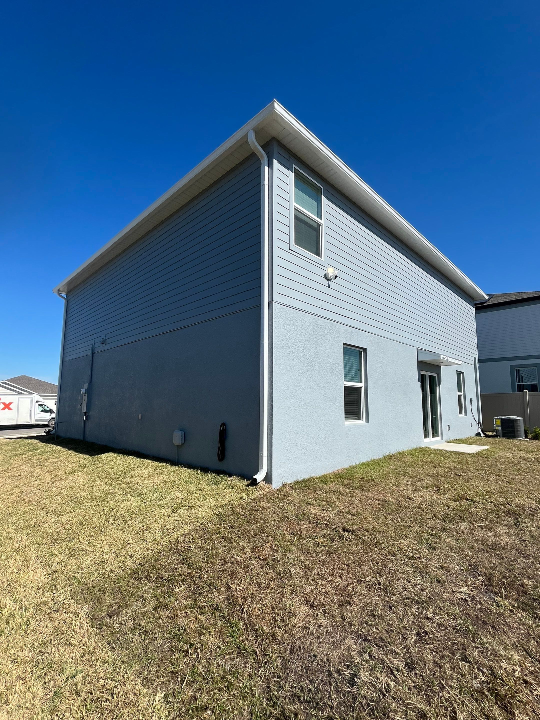 White Down Spouts and Seamless Gutters using downspouts in Dade City FL by Gutter Professors