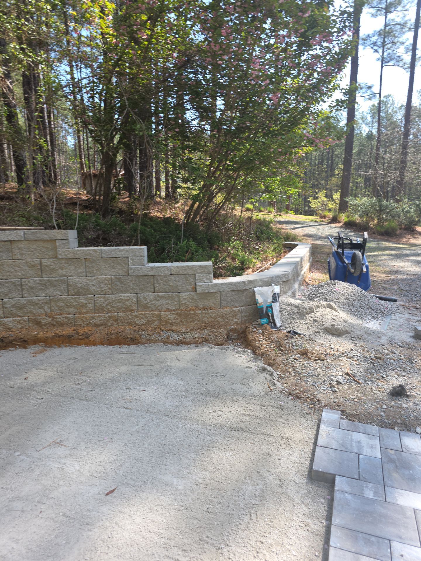 Pittsboro Outdoor Living Transformation – Retaining Wall, Paver Patio & Elevated Deck by Elite Remodeling and Design LLC