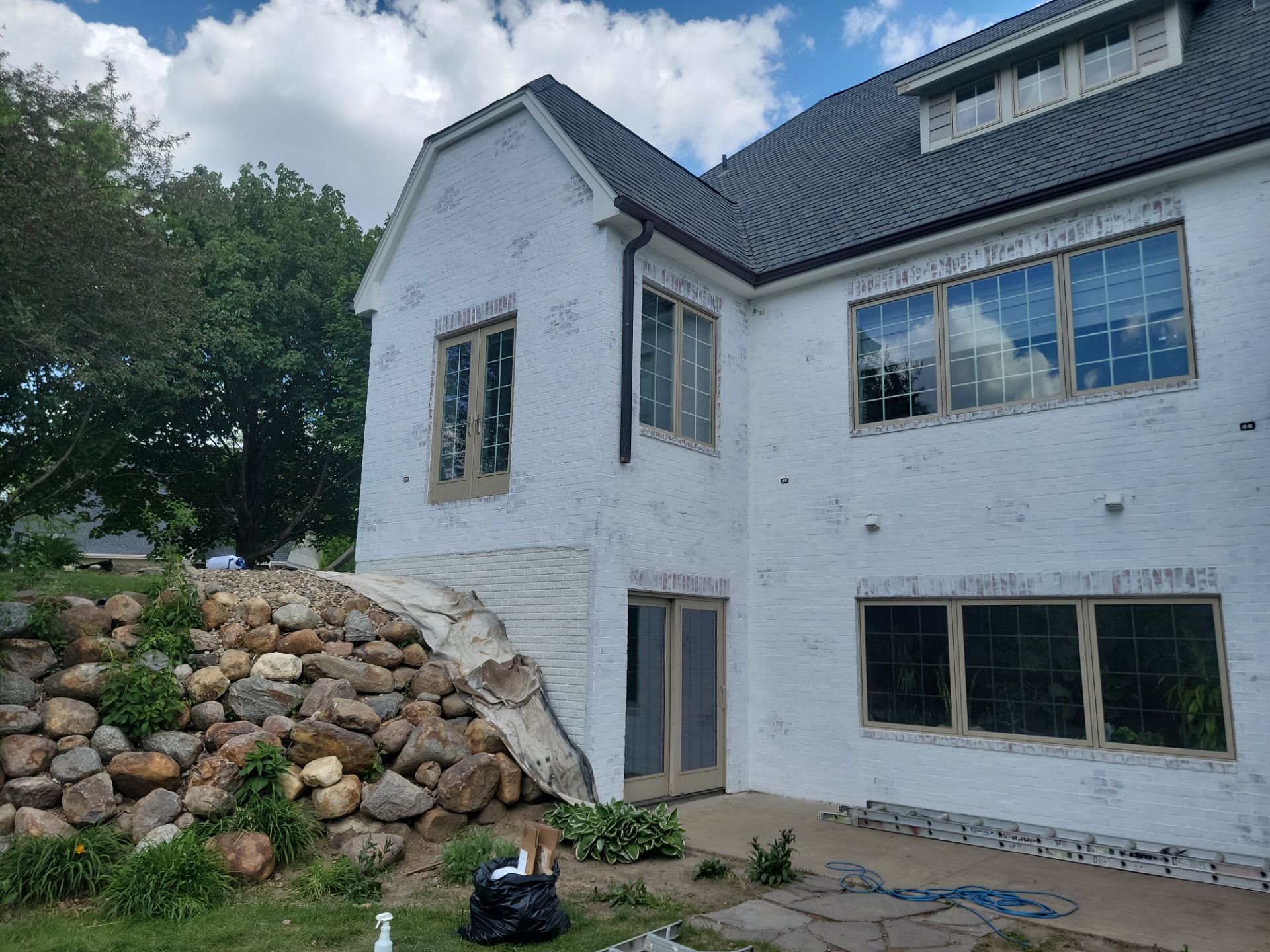 Residential Exterior Brick Painting and Limewash Refresh in Sioux Falls by Select Painting, Coatings & Garage Cabinets
