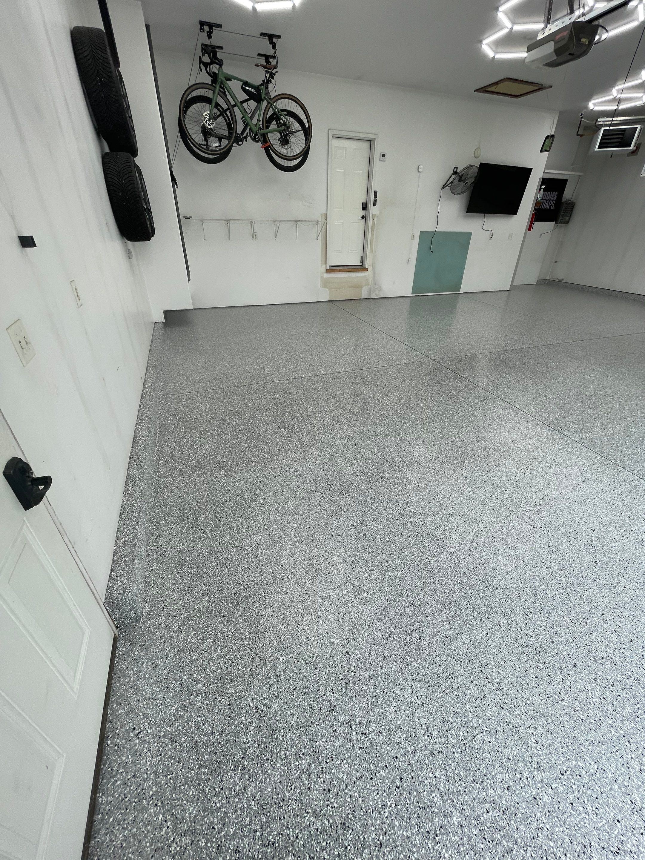 Feather Gray Epoxy Floor Coating Installation in Sioux Falls by Select Painting, Coatings & Garage Cabinets