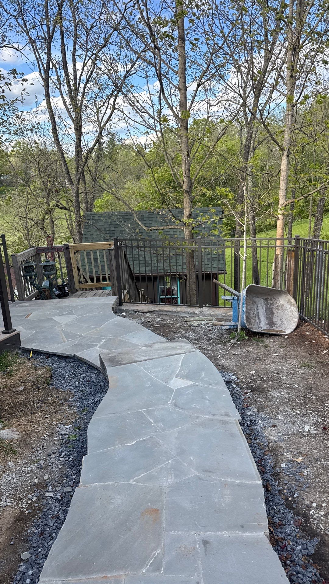 Custom Composite Deck with Stone Fireplace and Modern Cable Railing by Walnut Hollow Decks & Outdoor Living