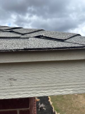 Close up of damaged asphalt shingle roof edge