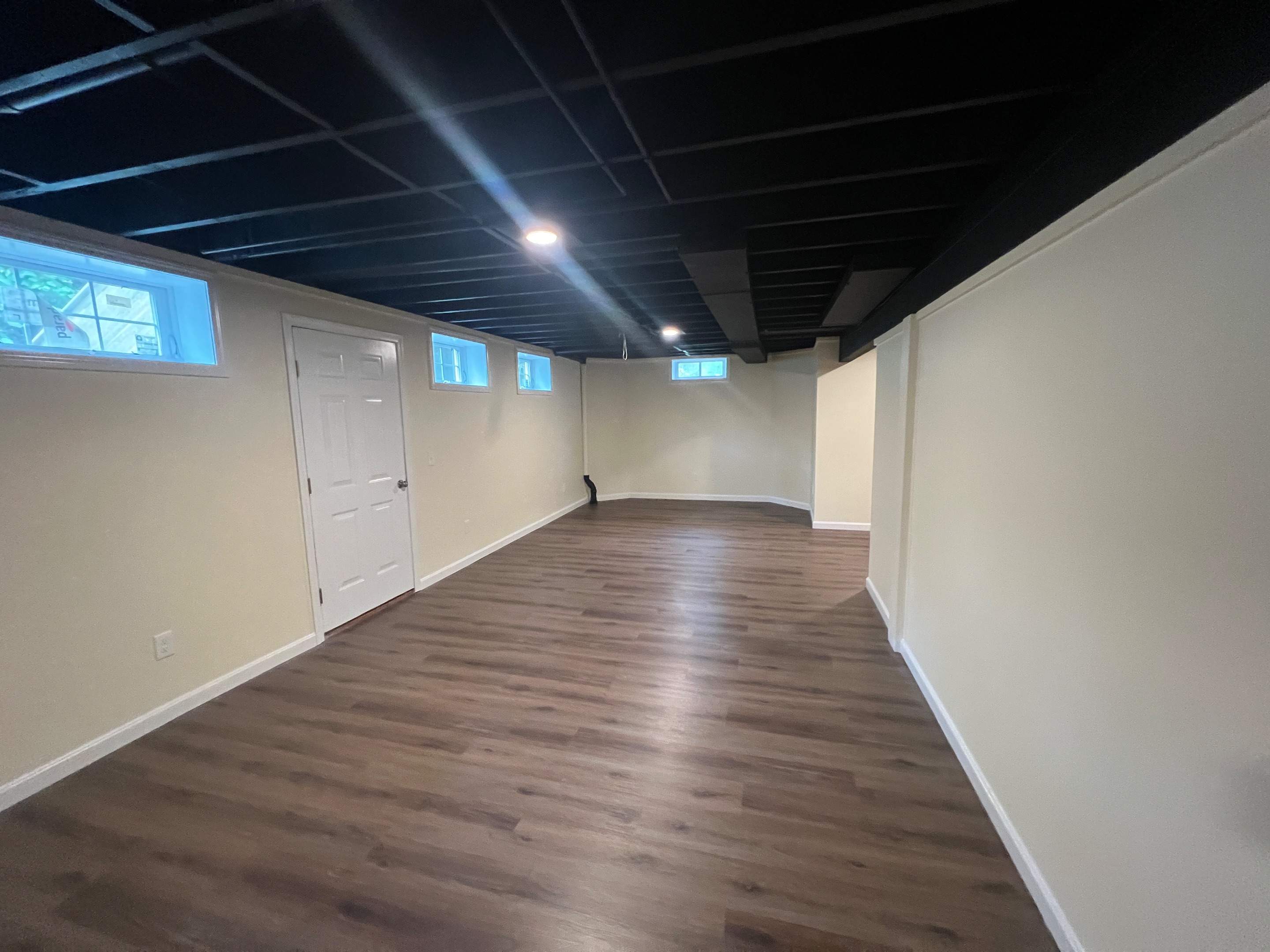 Basement Remodel w/ LVP Flooring & Exposed Ceiling by Chagnon Building & Remodeling LLC