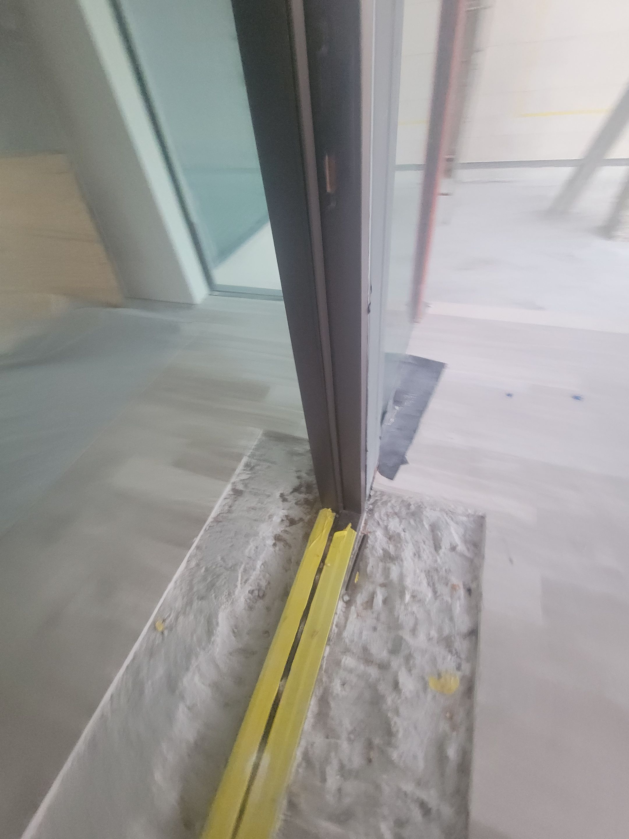 Custom Material Pivot Door installation by Impact Precious Wood Inc.