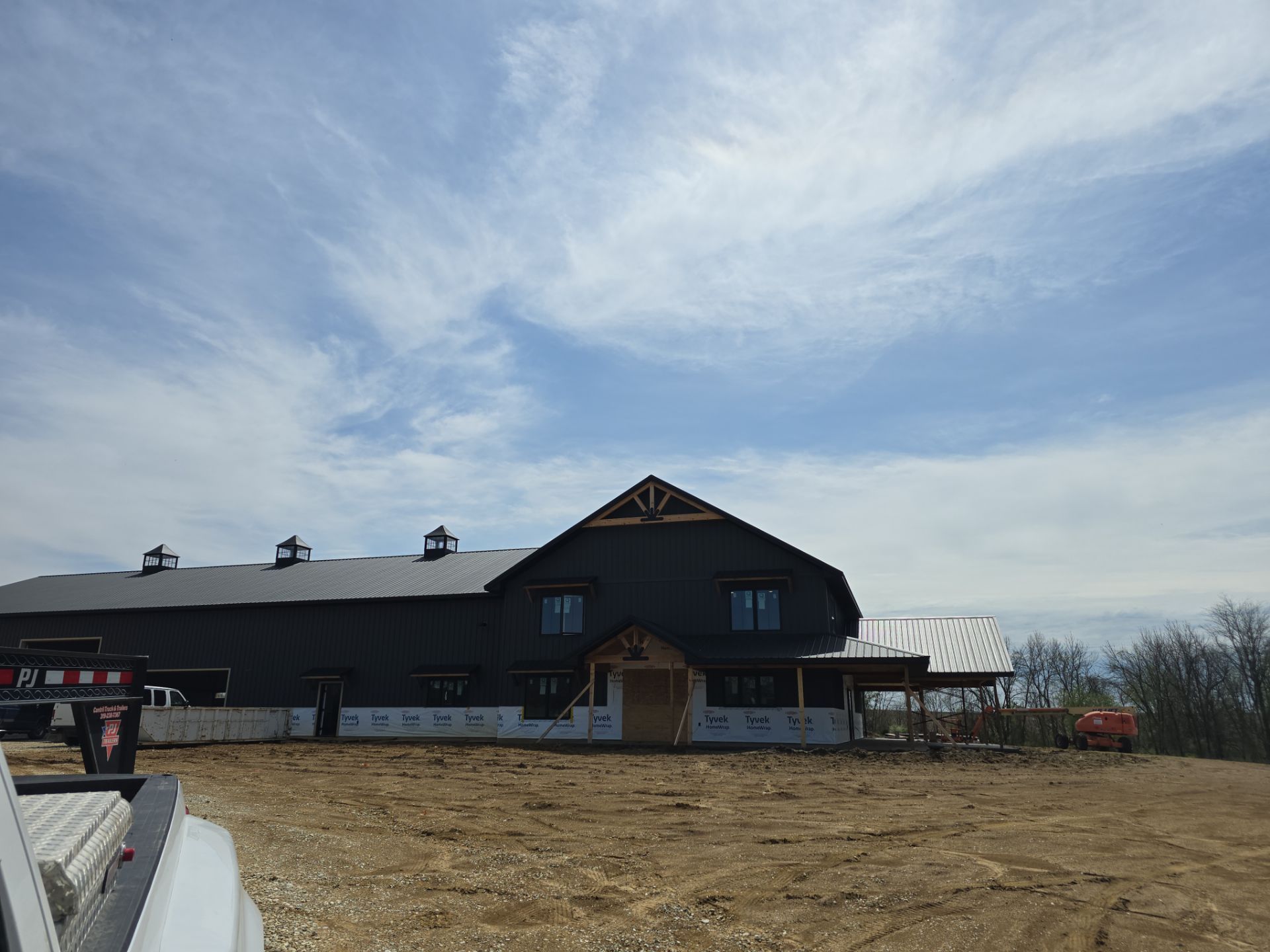 New Home construction w/ board and batten sides and metal roof  by Miles Construction 