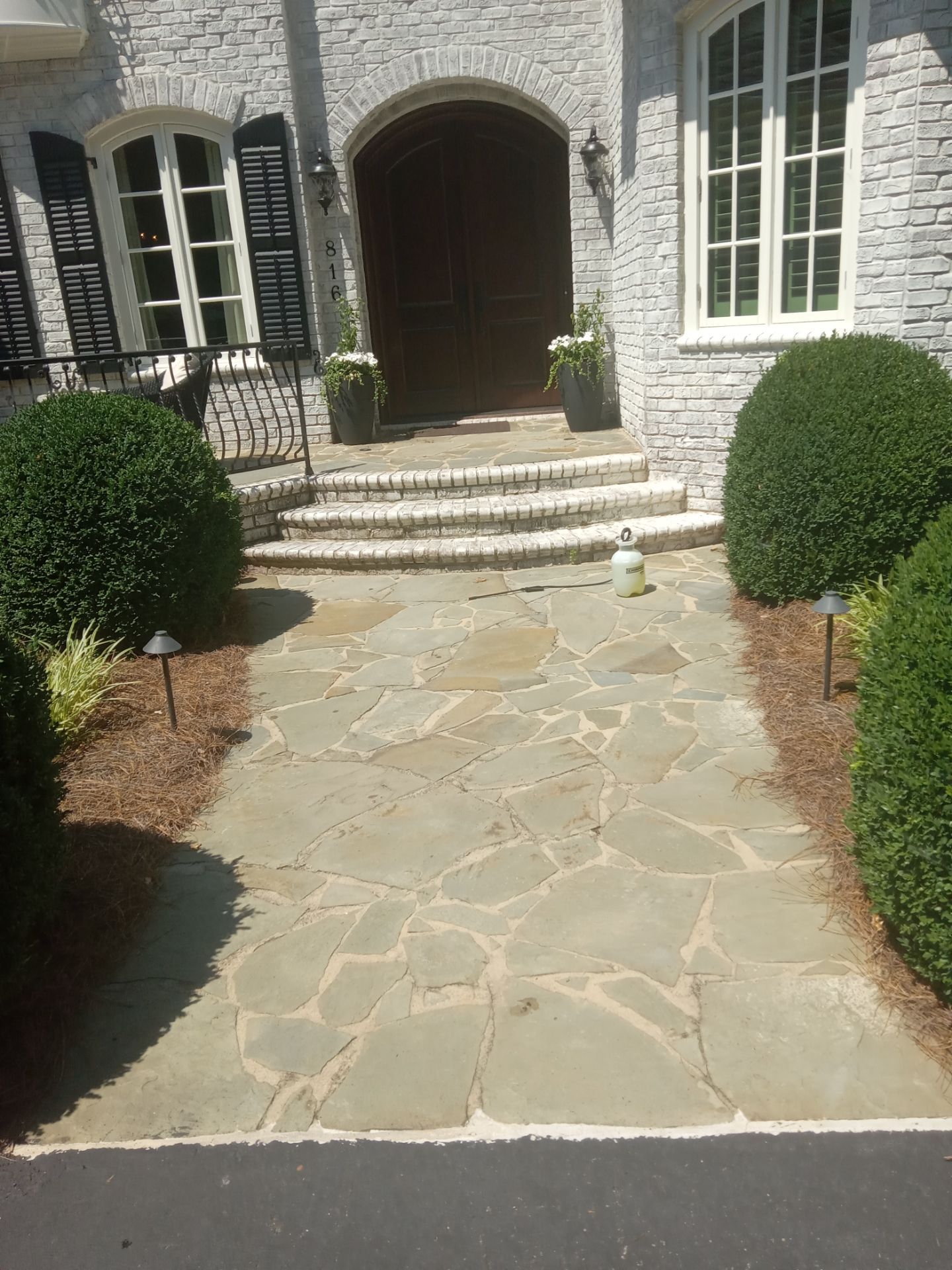 pressure washing stone walkway and steps removing dirt buildup for a clean appearance