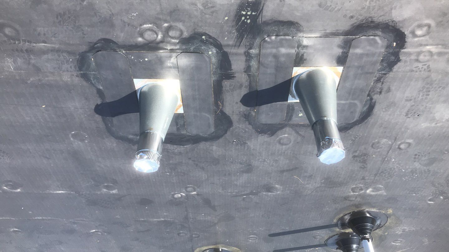 Commercial Roofing Installation using EPDM with white gutters by A Plus Exterior