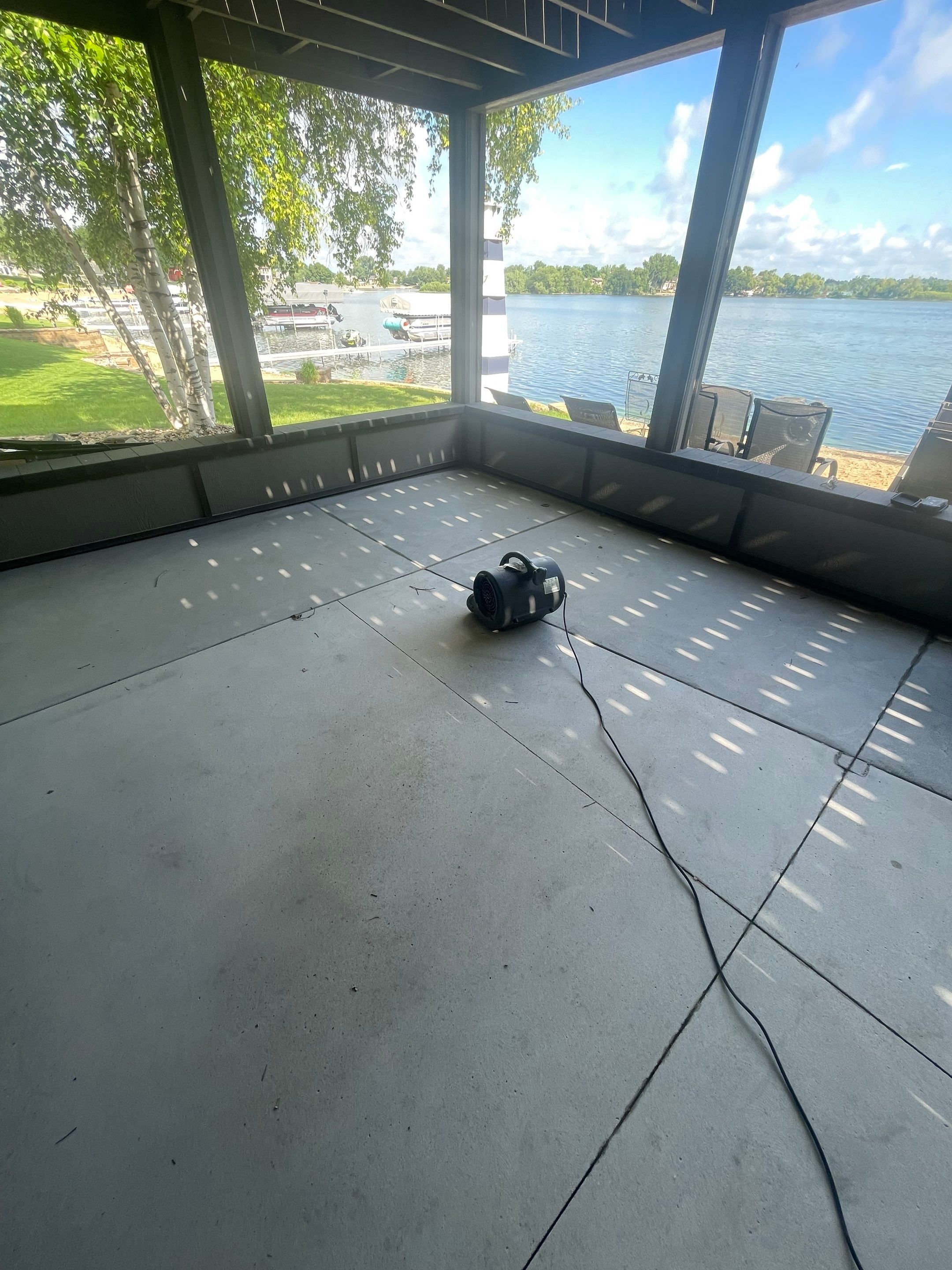 Lakefront Screened Patio Concrete Coating Installation in Wentworth by Select Painting, Coatings & Garage Cabinets