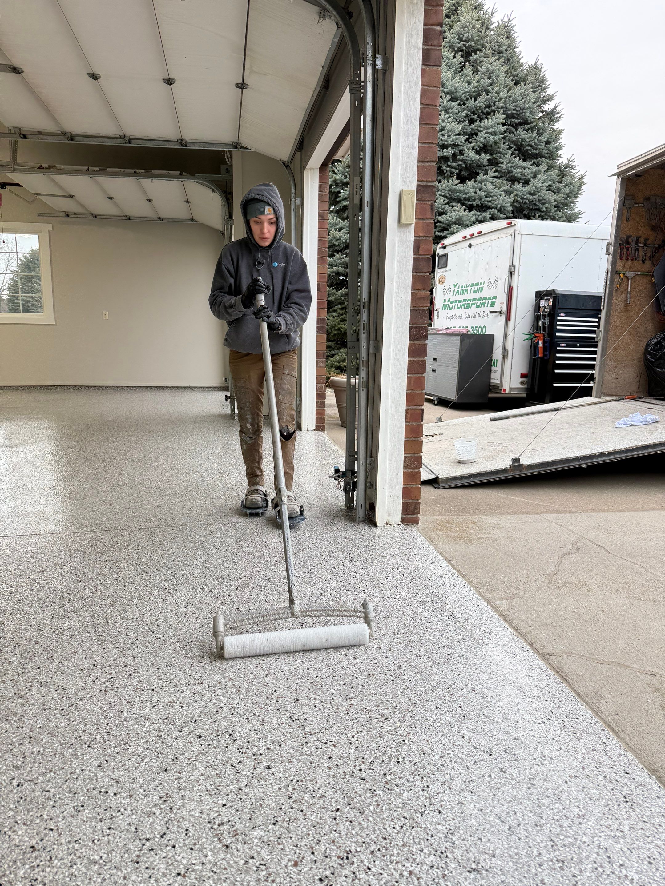 Garage transformation in Yankton by Select Painting, Coatings & Garage Cabinets