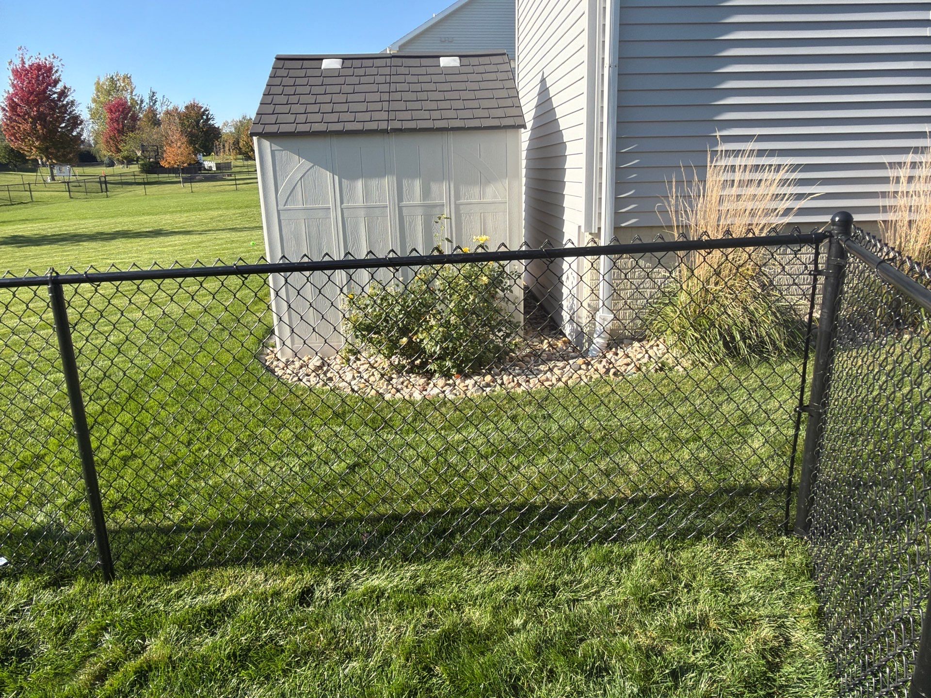 Black Vinyl-Coated Chain Link Fence Installation in Cedar Falls by Perfect Picket Fence and Stain