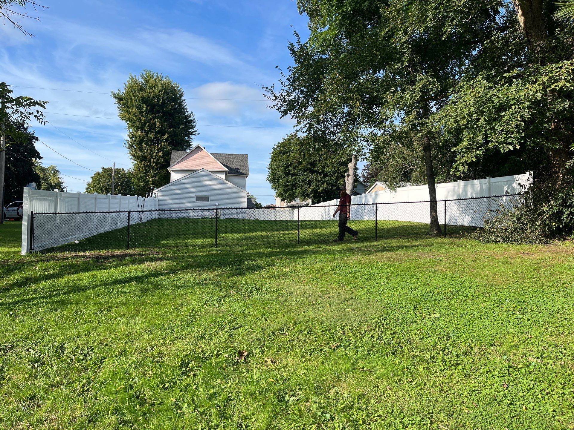 White Vinyl Privacy Fence and Black Chain Link Installation in Sumner by Perfect Picket Fence and Stain