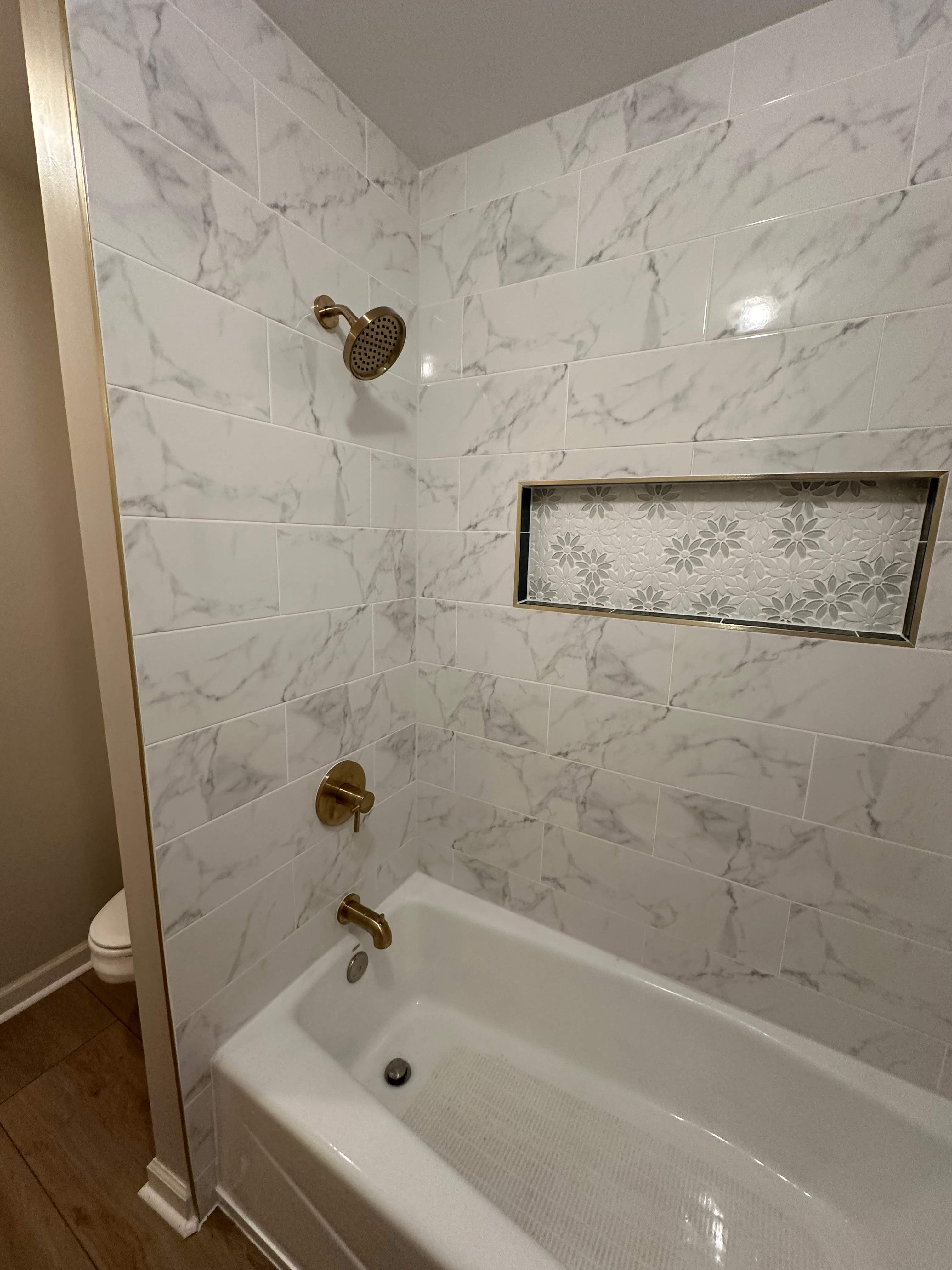 Tub retile, floor, vanities, mirror, and lights by Prudencio