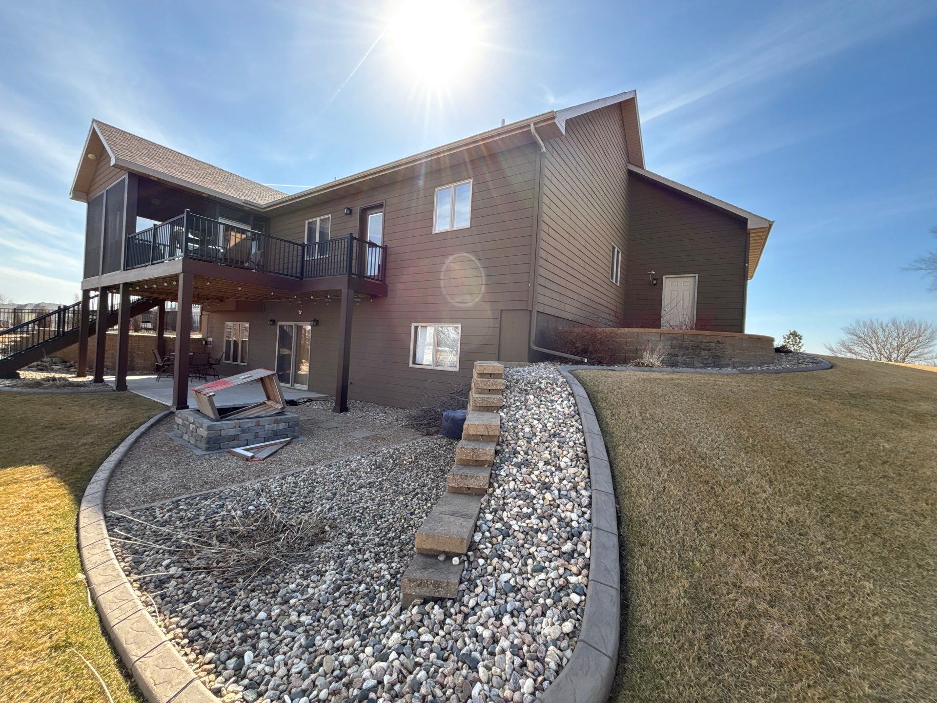 Full Exterior Renovation with Stone Veneer and Composite Decking by Select Painting, Coatings & Garage Cabinets