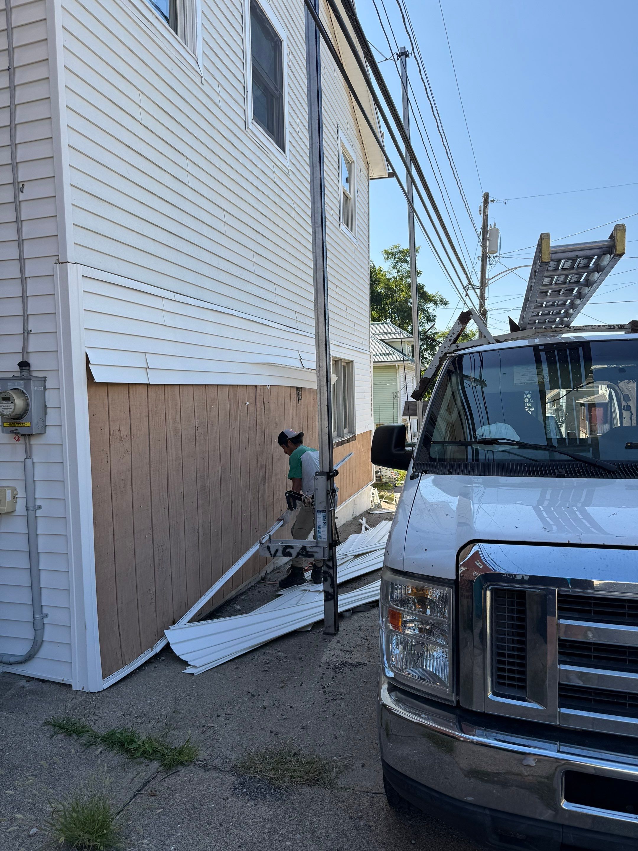 White siding  by Cousins Roofing Siding & Decks