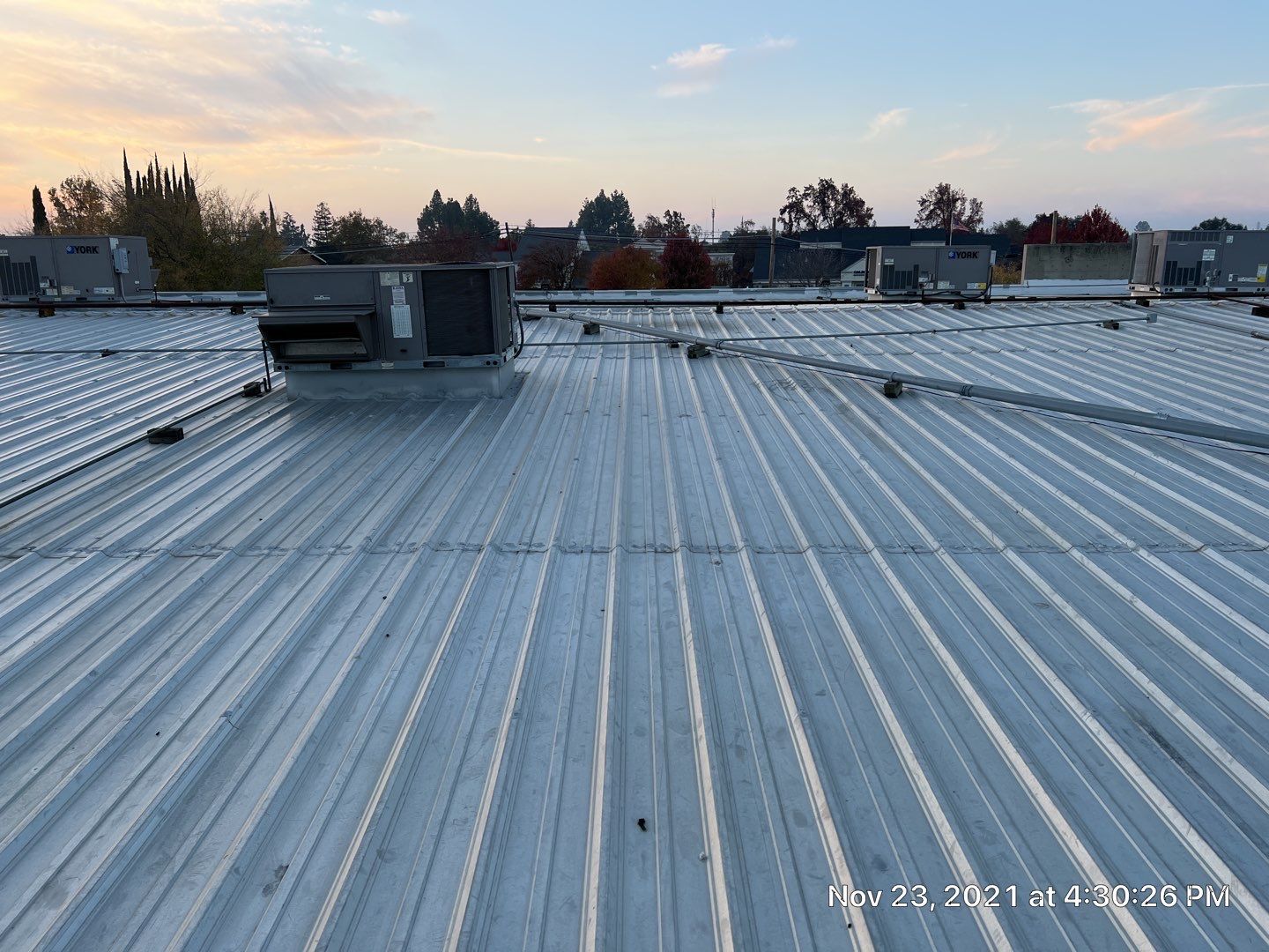 Metal roof restoration on commercial roof using Conklin Benchmark/ PUMA XL acrylic coatings over metal and foam by Straight Edge Roofing Inc