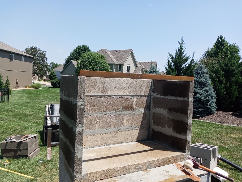 Back Yard Fireplace and Landscape by LAND ESCAPES LLC