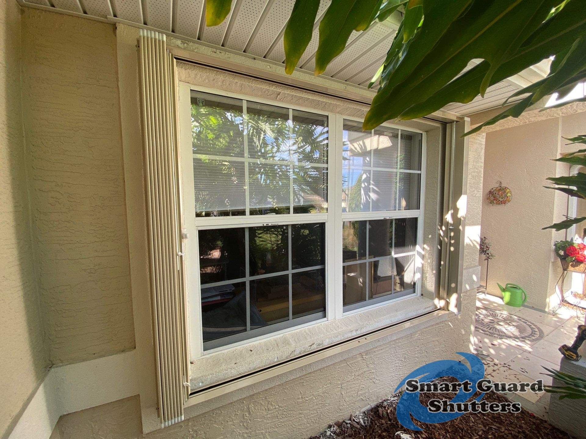Accordion Shutters in Beige by Smart Guard Shutters