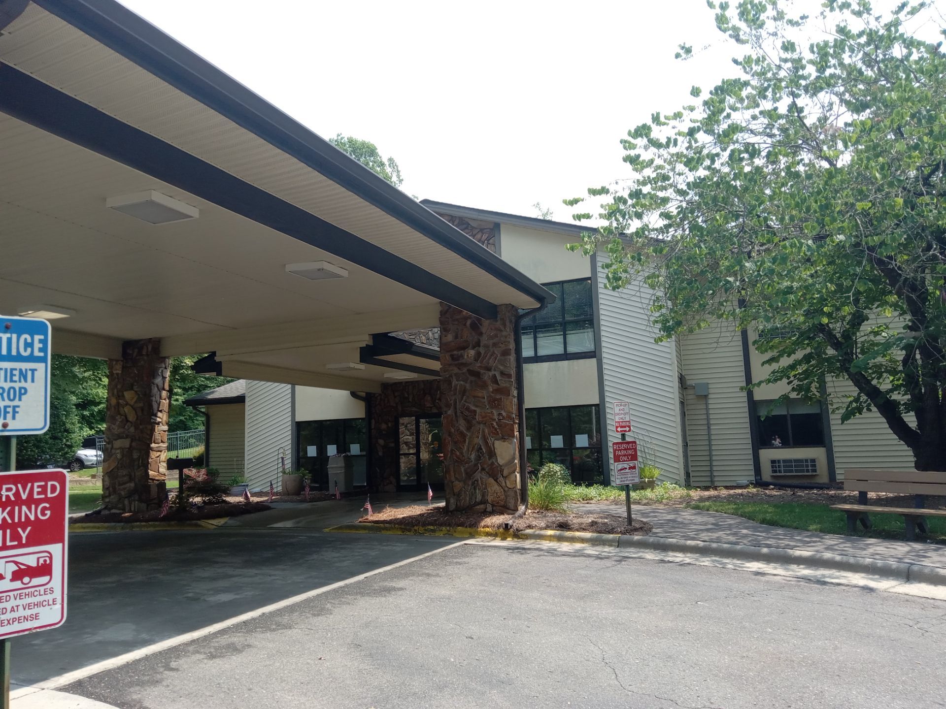 pressure washing concrete driveway and stone pillars at commercial building entrance