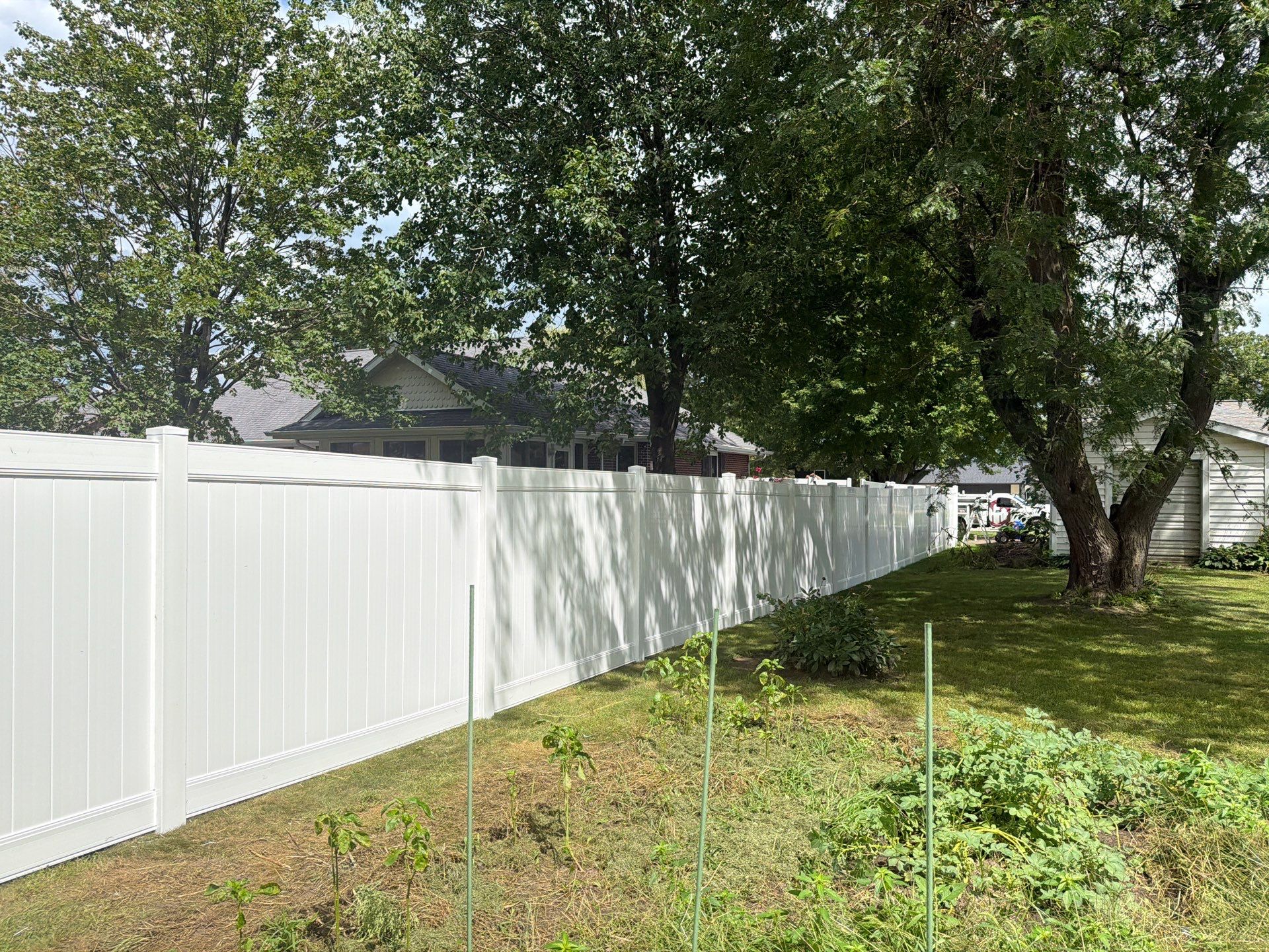 Residential White Vinyl Privacy and Black Chain Link Fencing in Jesup by Perfect Picket Fence and Stain