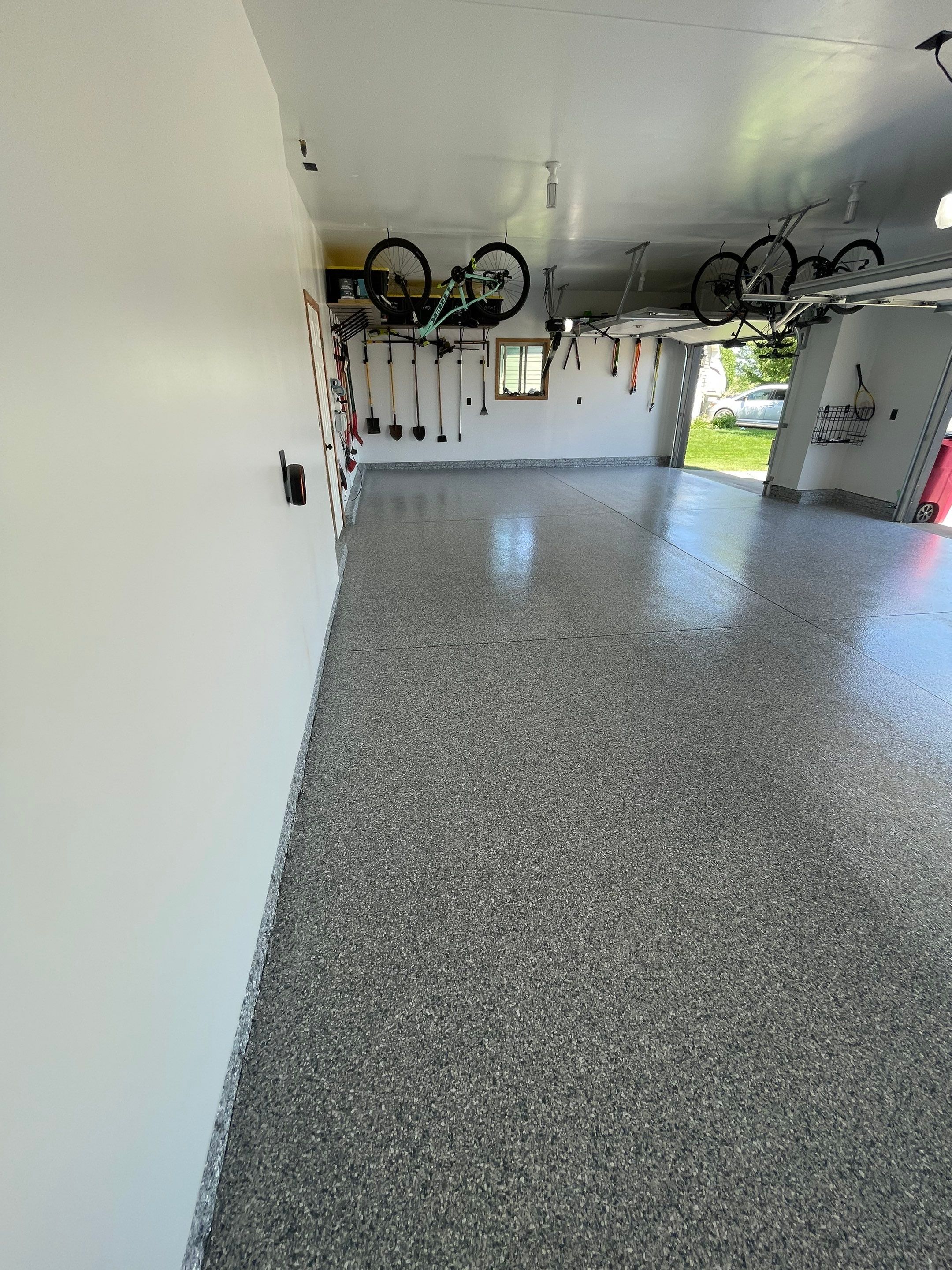 Tidal Wave Flake Garage Floor Installation in Sioux Falls by Select Painting, Coatings & Garage Cabinets