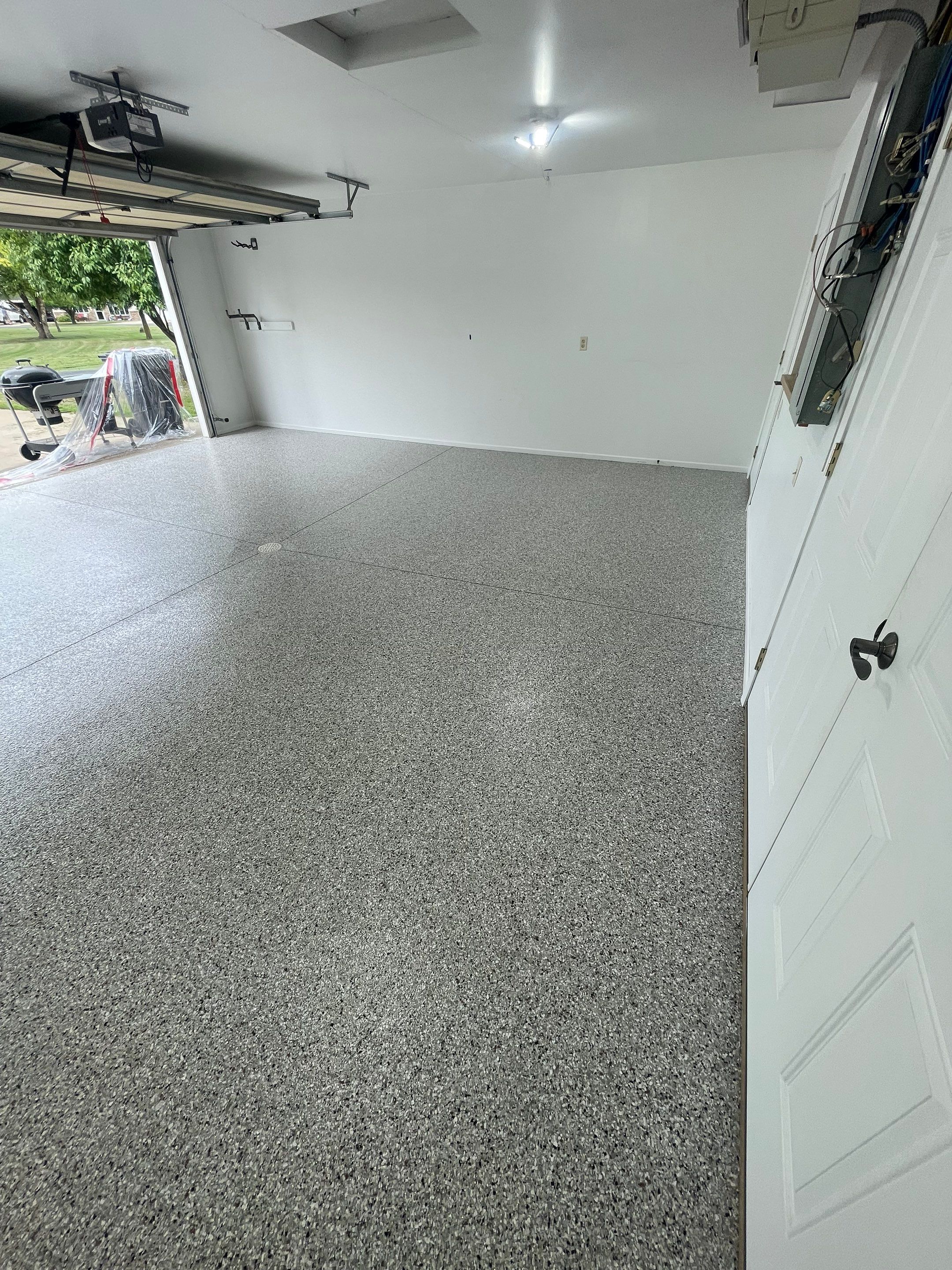 Coyote Flake Garage Floor Coating in Worthington, Minnesota by Select Painting, Coatings & Garage Cabinets