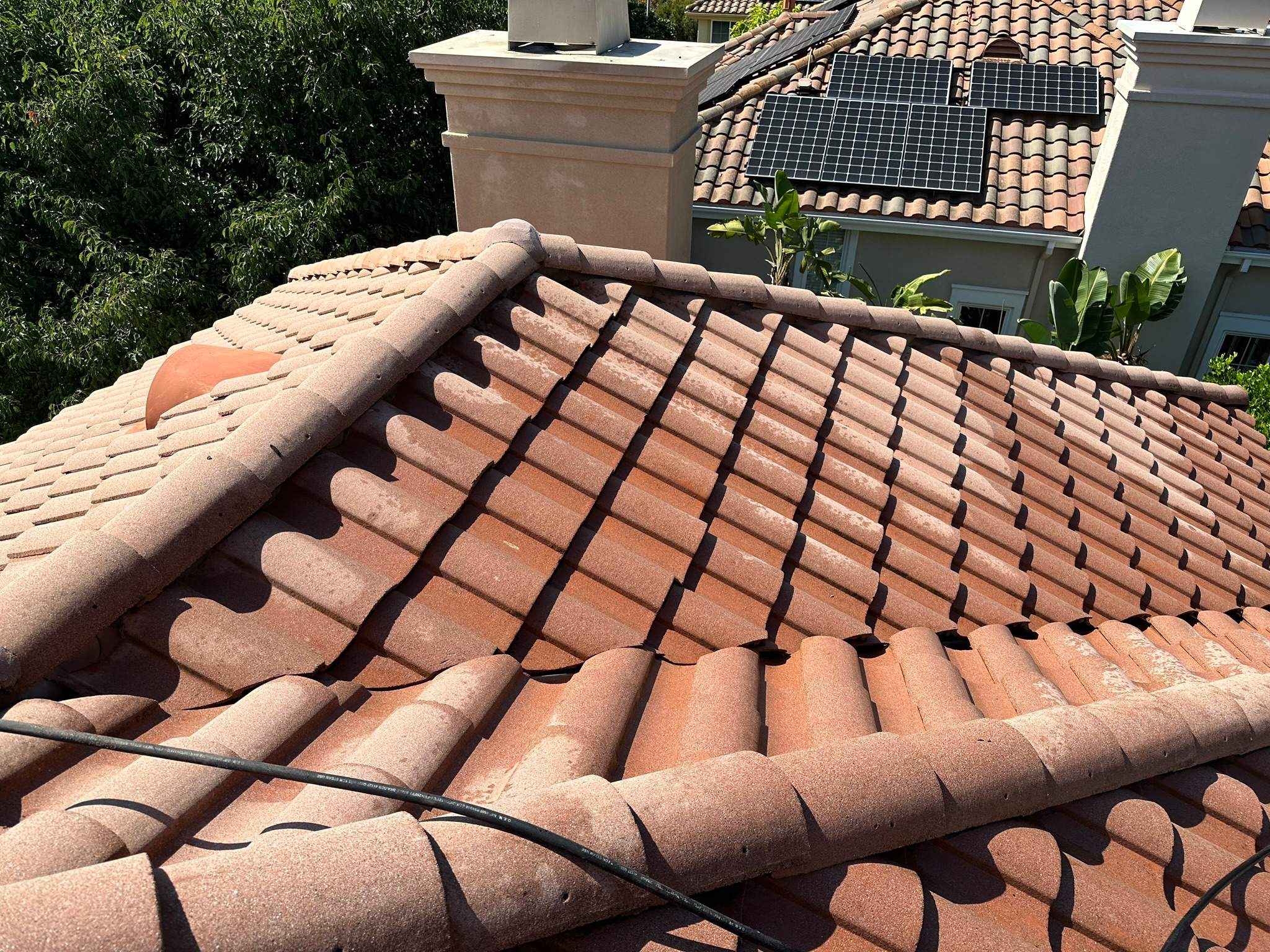 Roof wash on this dirty roof covered in algae by Property Cleaning Experts, LLC
