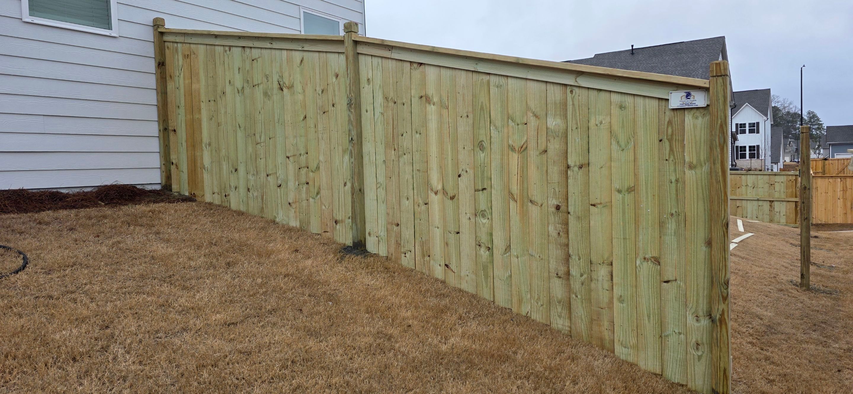 Fence Installation of Capped Wood Privacy with dado cut posts by Titans of Timber Fence & Stain