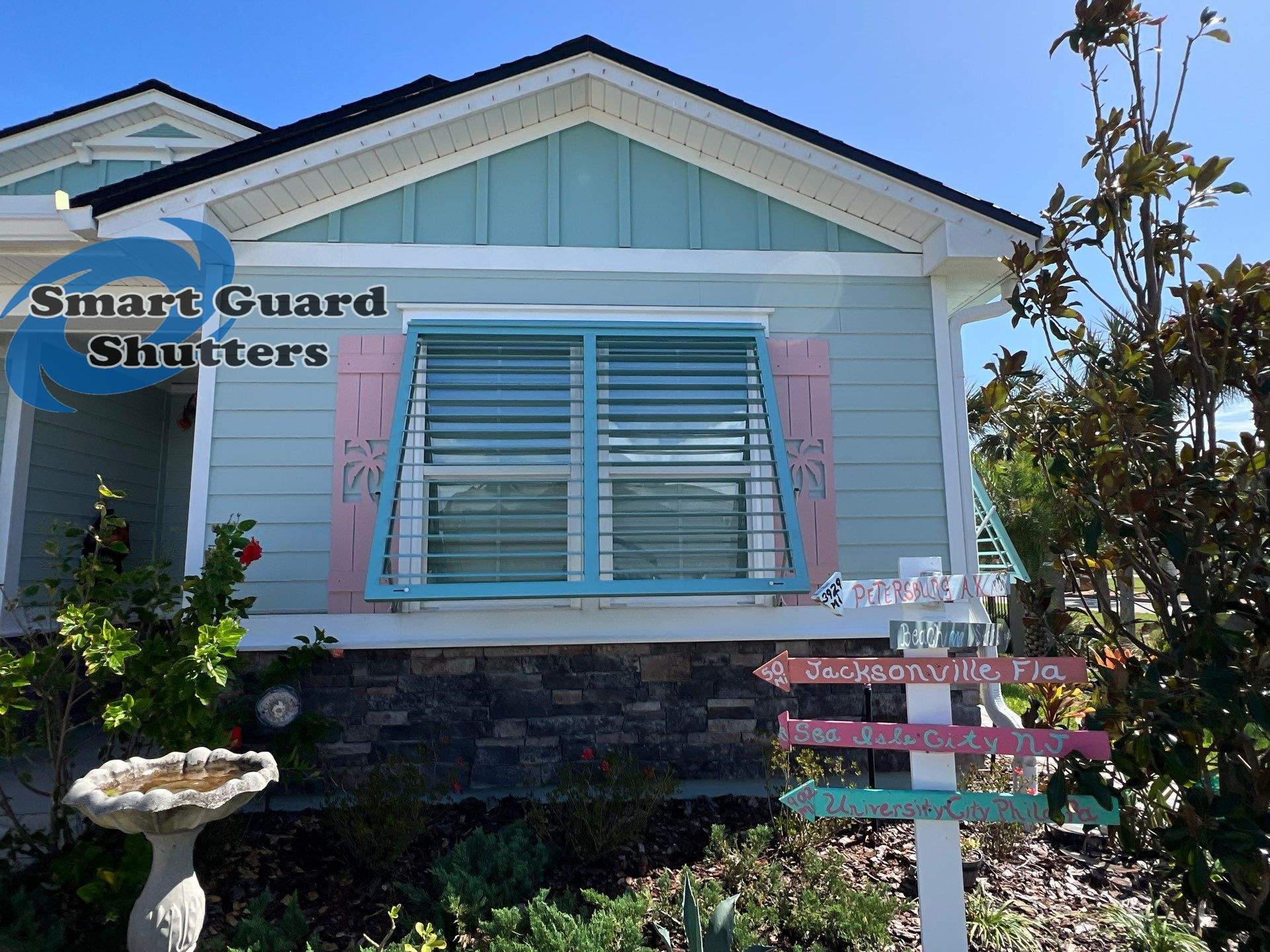 Impact Bahama Shutters in Pastel Turquoise by Smart Guard Shutters