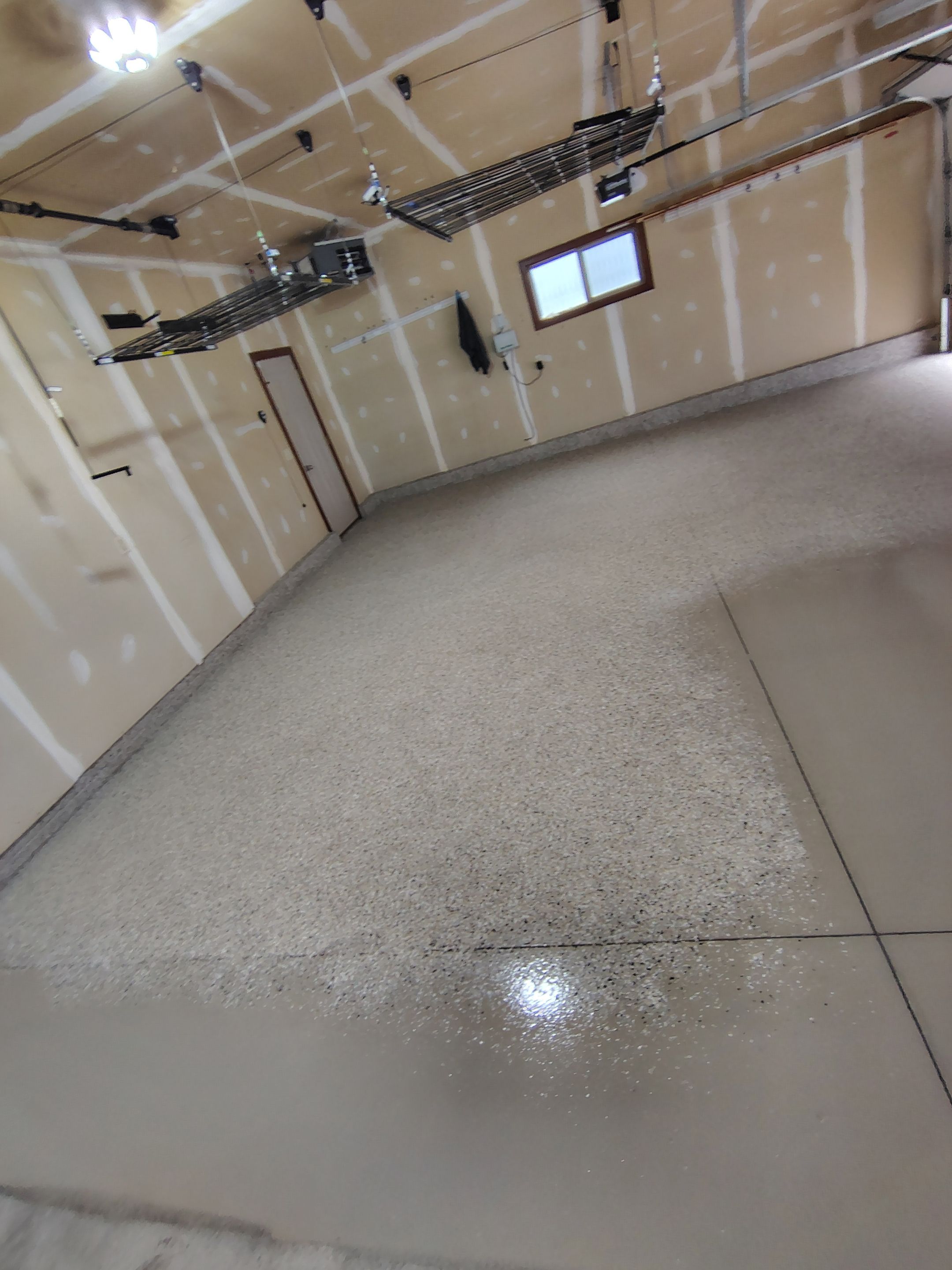Multi-Car Garage Concrete Coating and Epoxy Finish in Sioux Falls by Select Painting, Coatings & Garage Cabinets