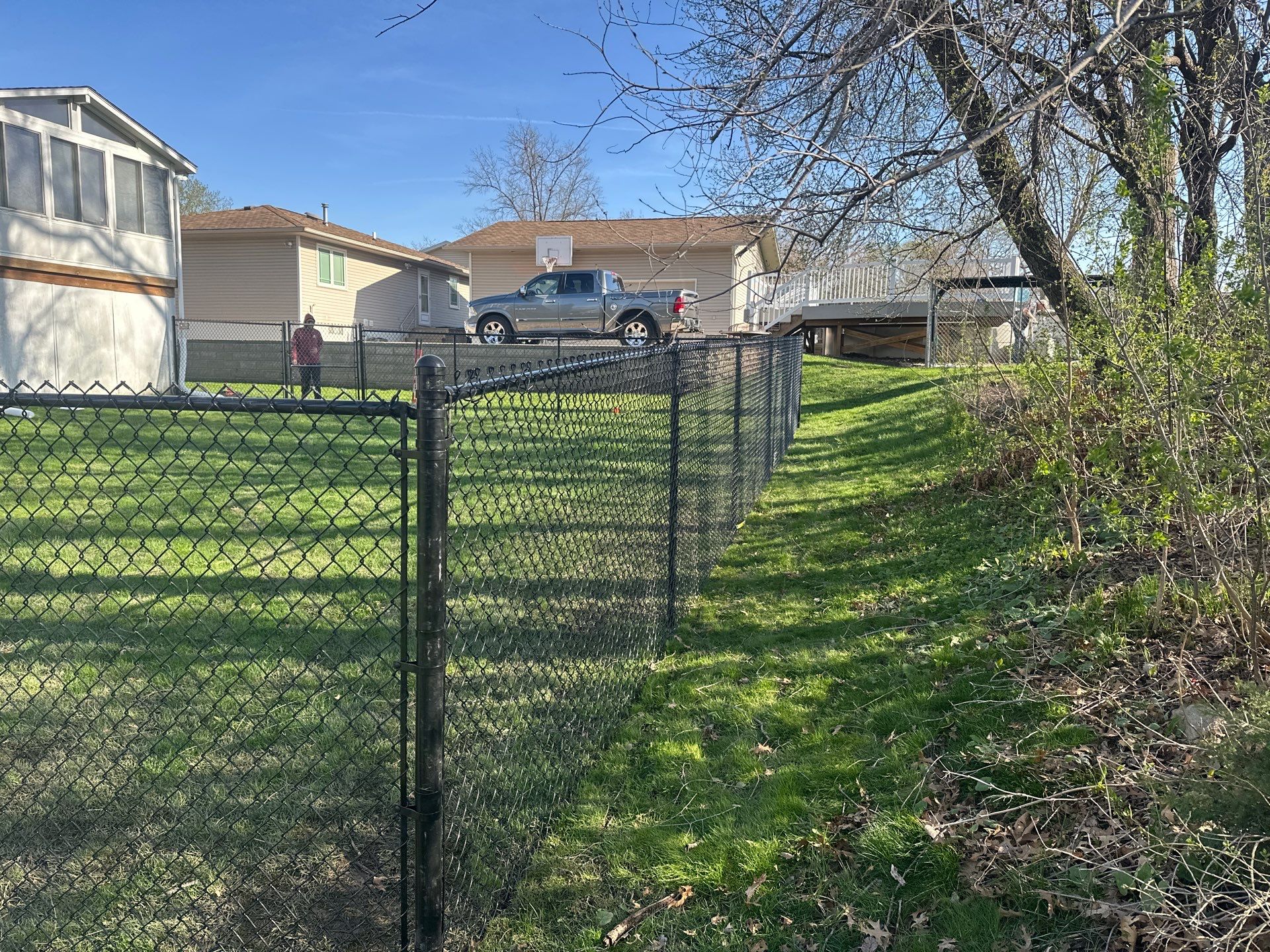 Black Vinyl-Coated Chain Link Fence Installation in Waterloo by Perfect Picket Fence and Stain