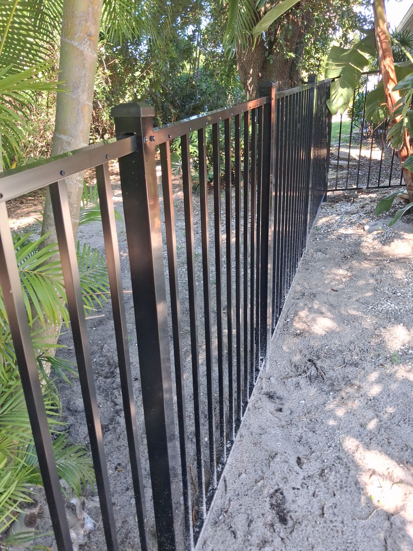 Black Aluminum Picket Fence Installation for Port Charlotte Canal Home by True Fence LLC