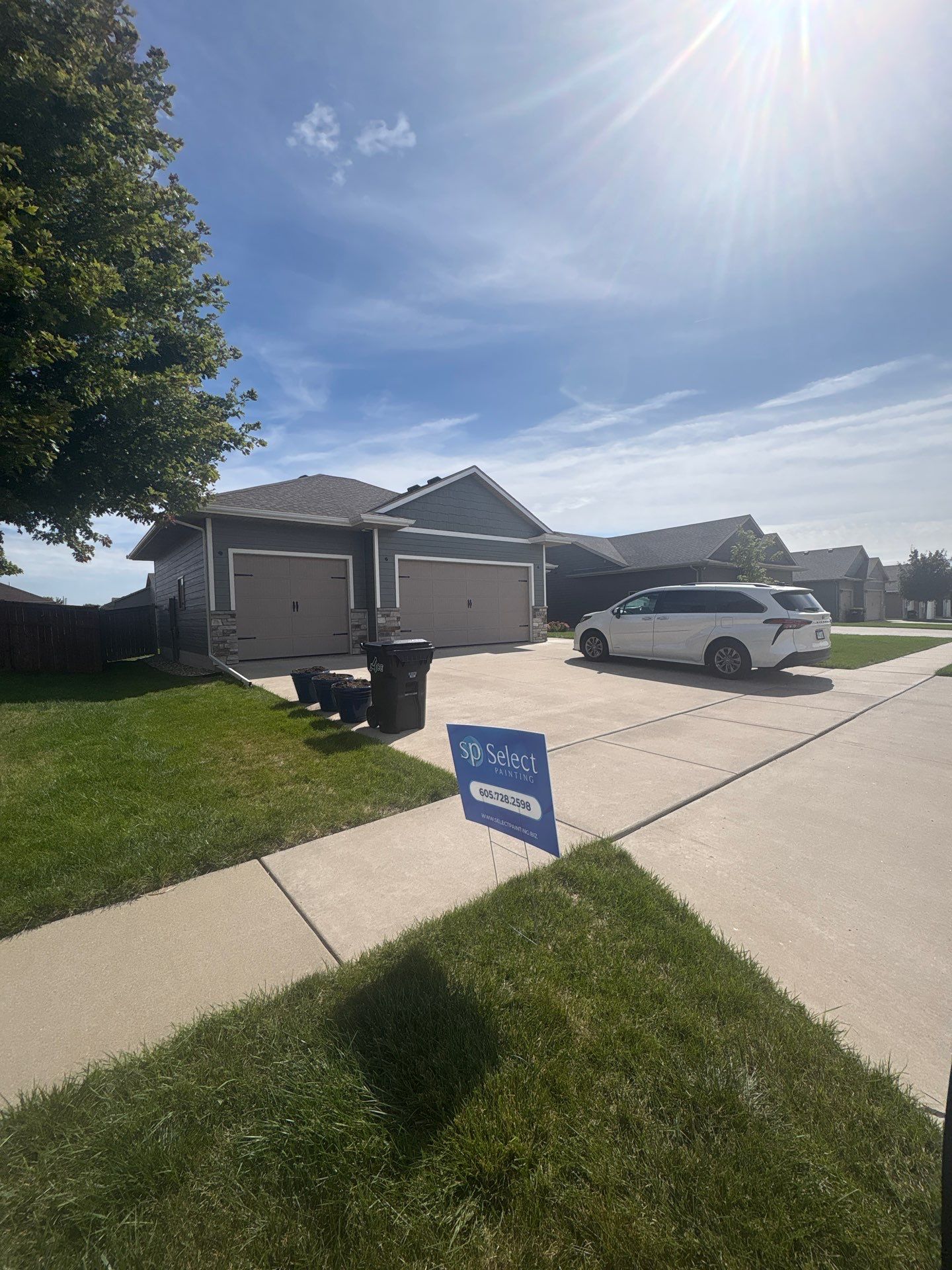 Full Exterior Home Painting on Blue Lap Siding in Sioux Falls by Select Painting, Coatings & Garage Cabinets