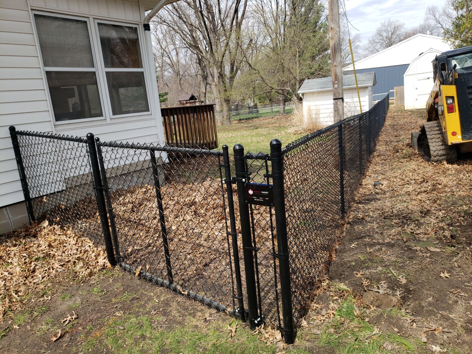 Black Vinyl-Coated Chain Link Fence Installation in Cedar Falls by Perfect Picket Fence and Stain