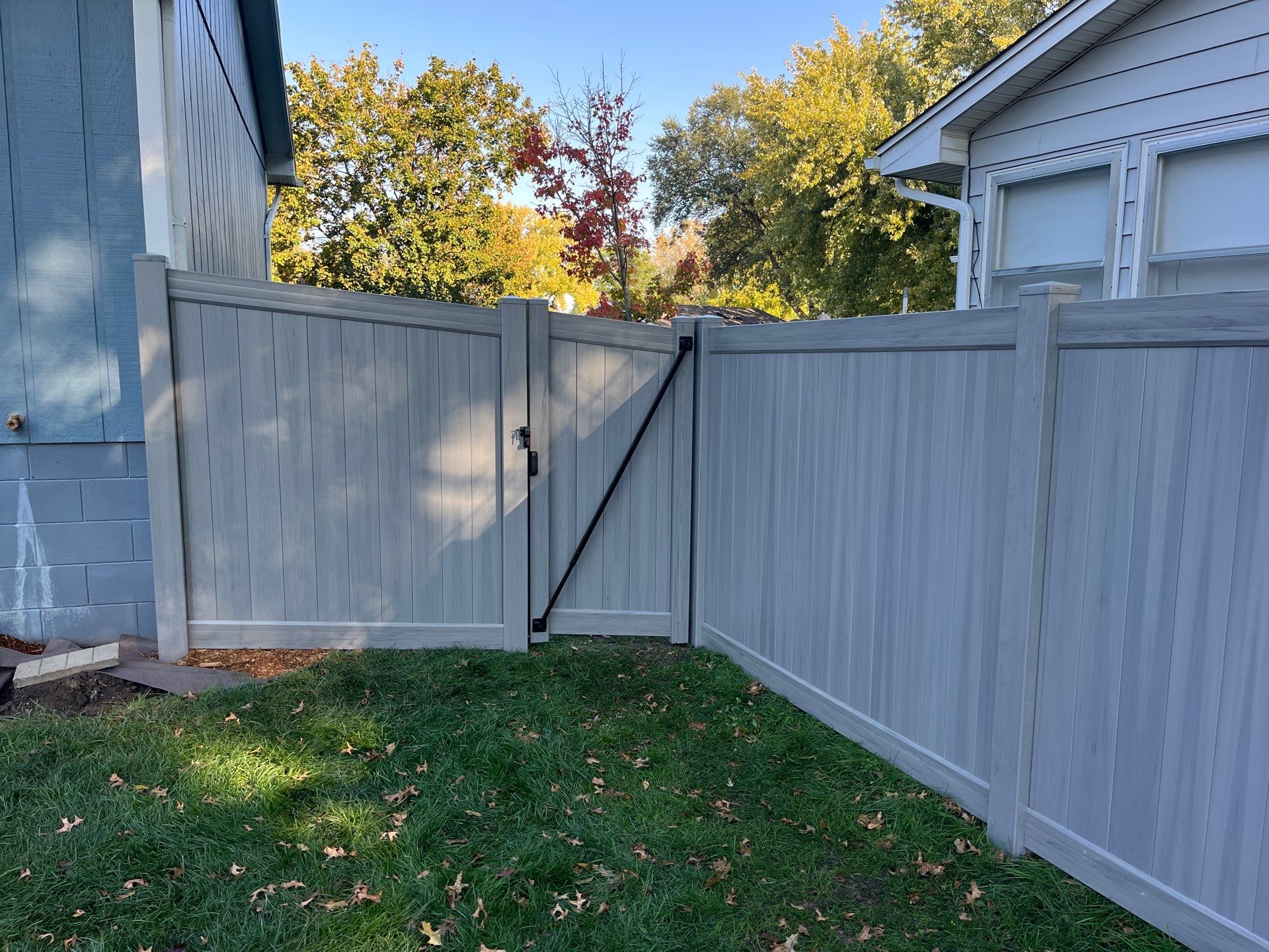 Chai Gray Vinyl Privacy Fence and Gate Installation in Cedar Falls by Perfect Picket Fence and Stain