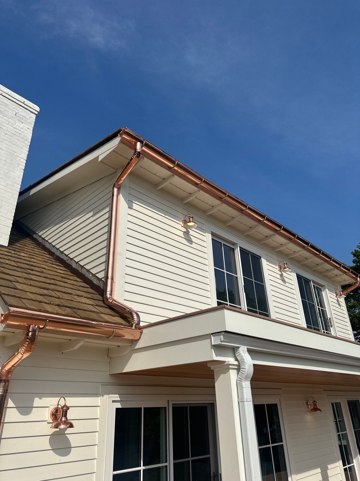 Custom Copper Gutter System and Accent Roofing in East Jordan by Rainbow Seamless Systems